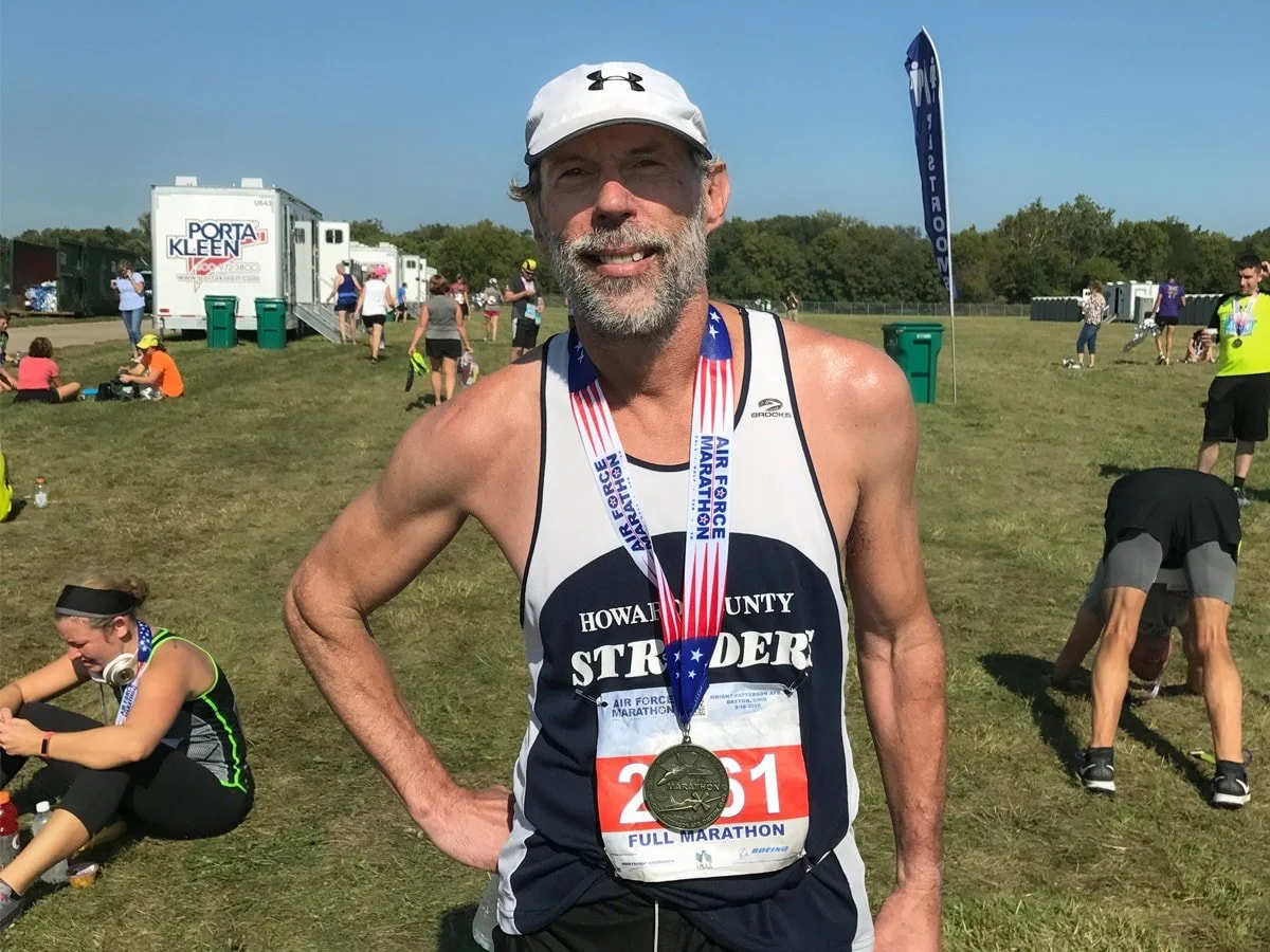 Greg Schuler, wearing a finishers medal at the conclusion of the Air Force Marathon