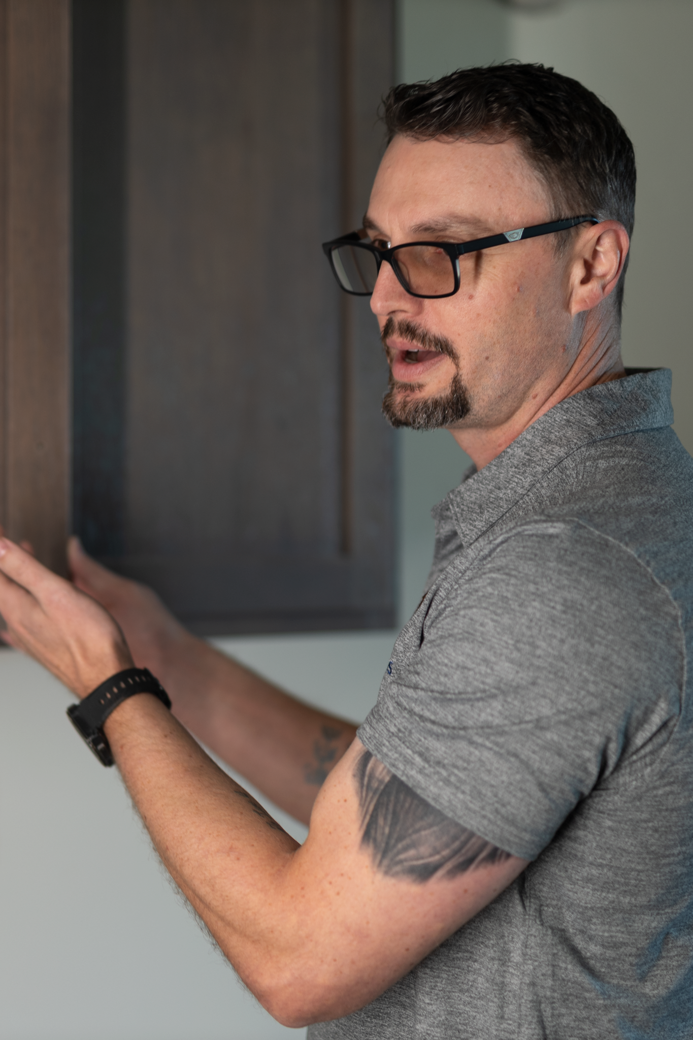 Owner opening and showing kitchen cabinet.