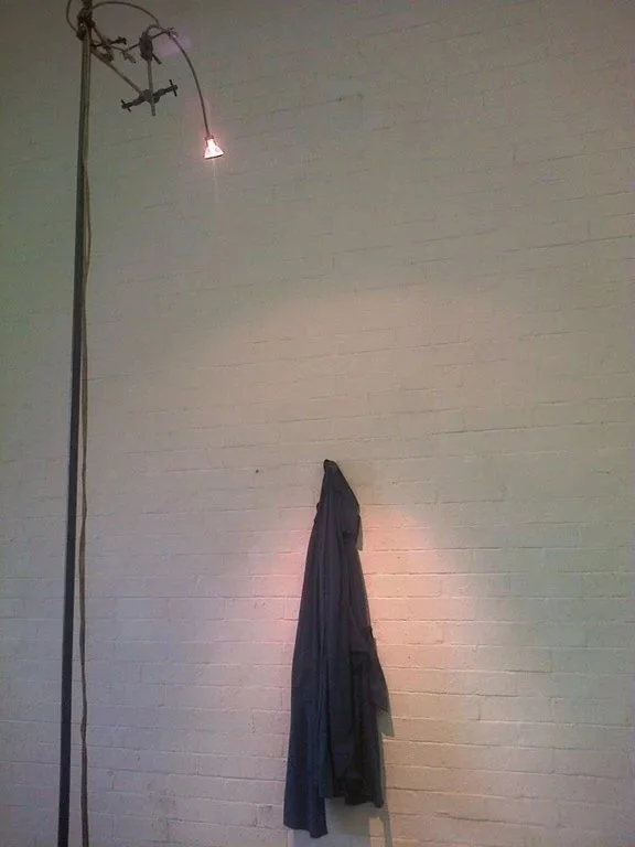 izinyoka (2013) installation detail (light bulb and wet jacket 