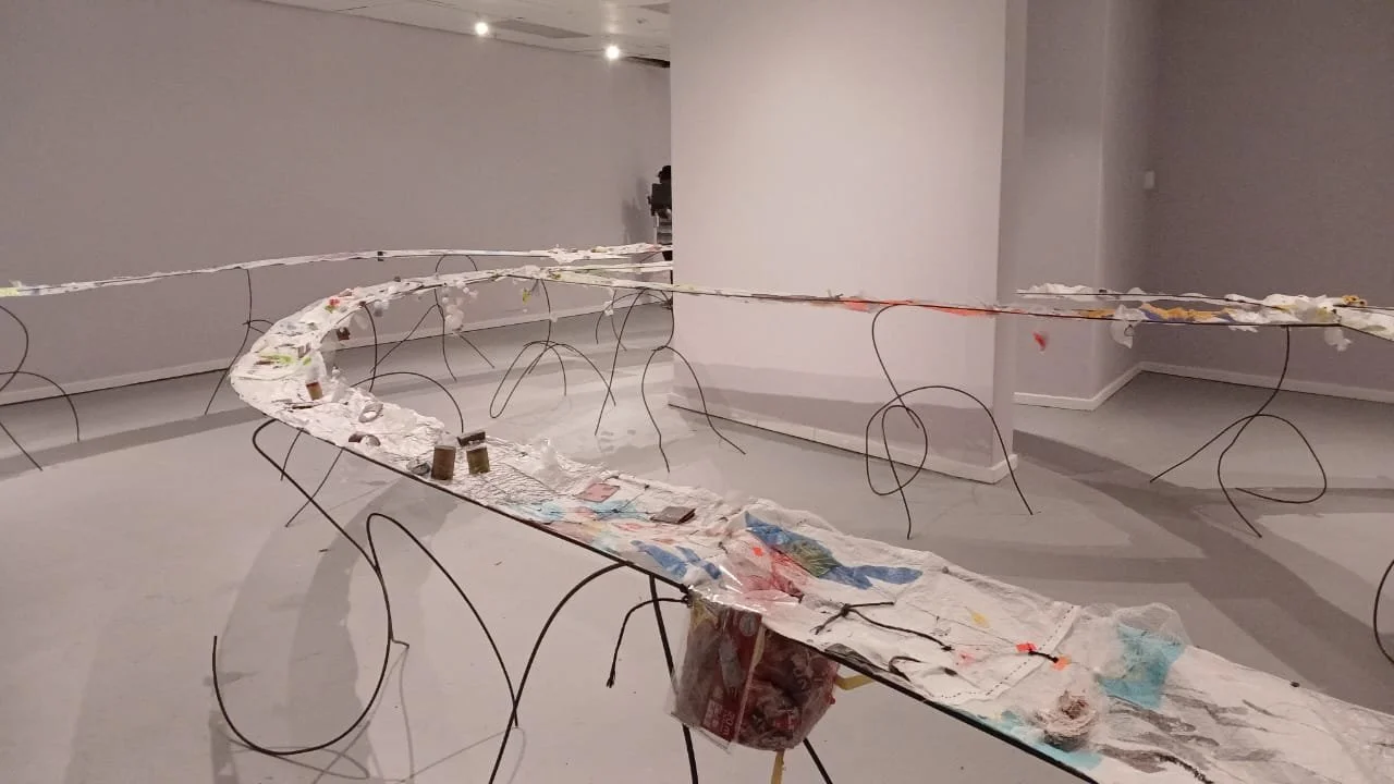 to teach in ways that teach us to care for the soul (2025) drawing installation. mixed media drawing on round bar trestles. installation detail 