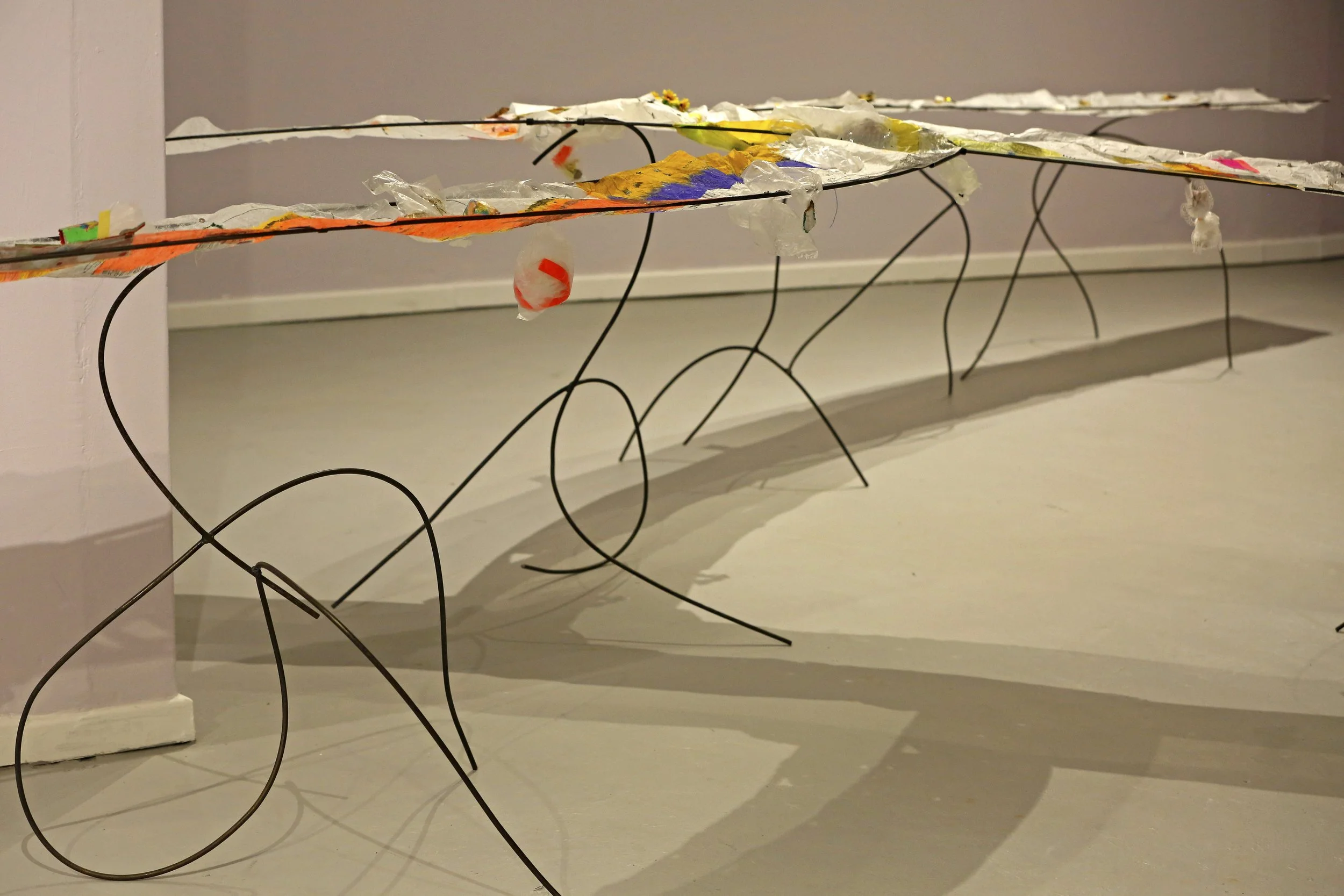 to teach in ways that teach us to care for the soul (2025) drawing installation. mixed media drawing on round bar trestles. installation detail