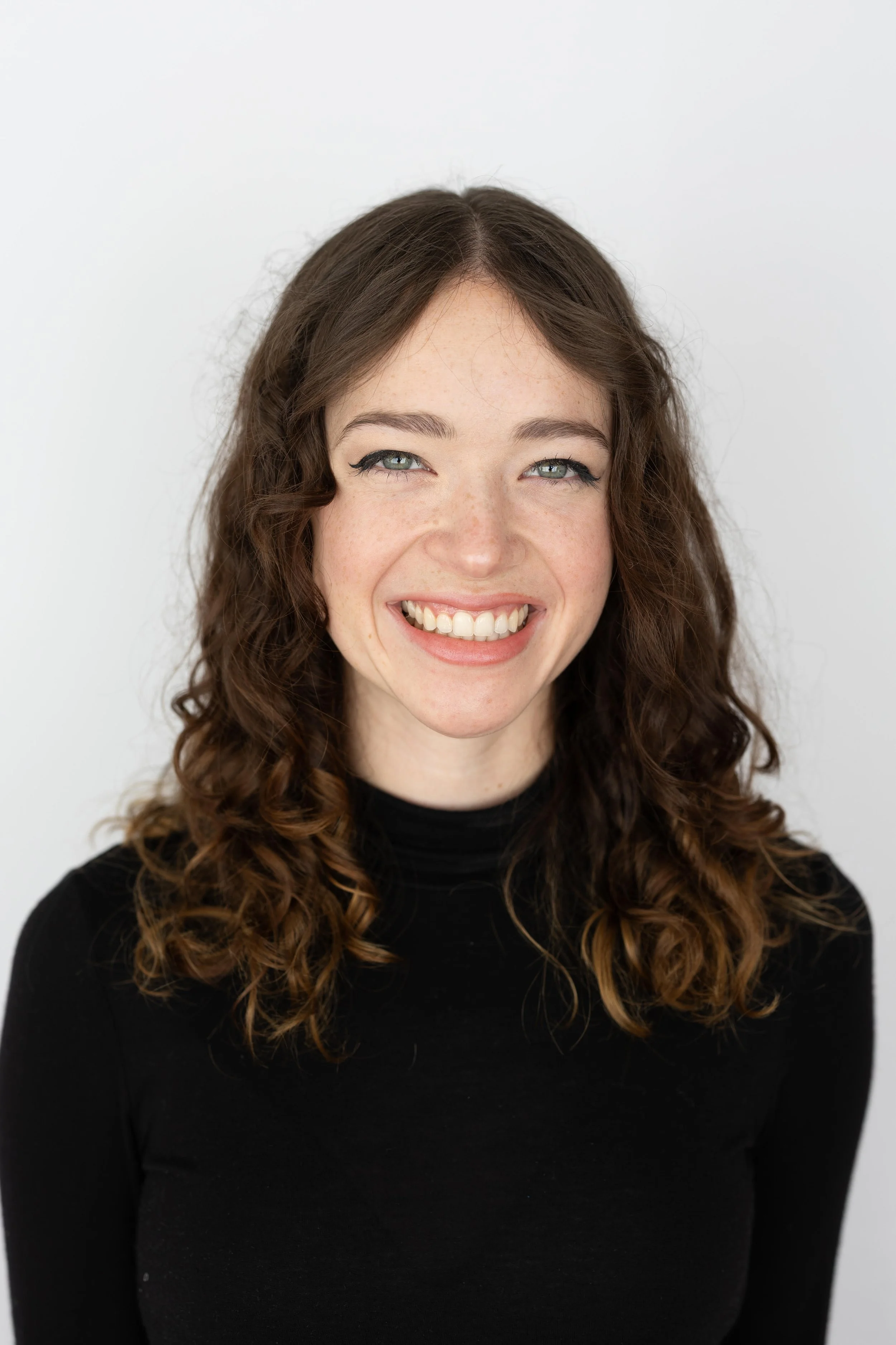 A dancer in mid-air leap on a stage with a blue background and the words "Arsenaling Dance" displayed in large letters.