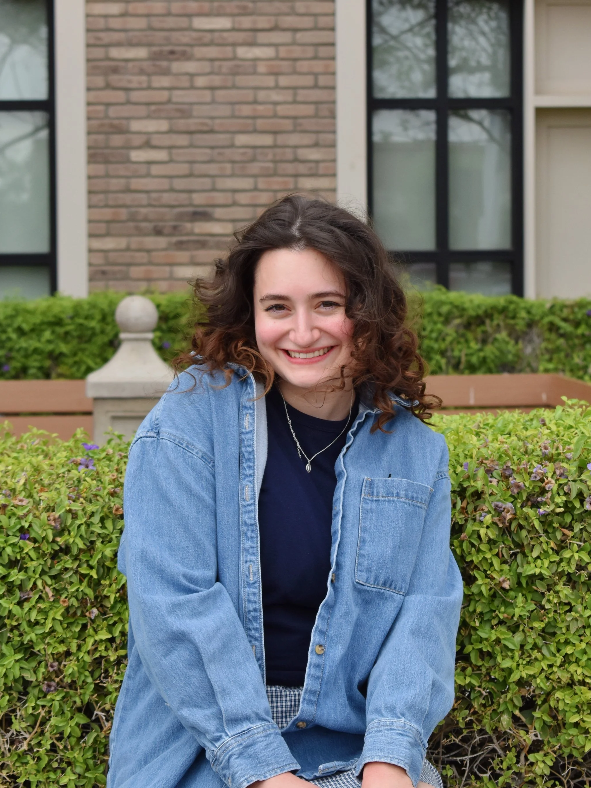 Clare, digital marketer and content creator, smiling outdoors in a casual professional setting