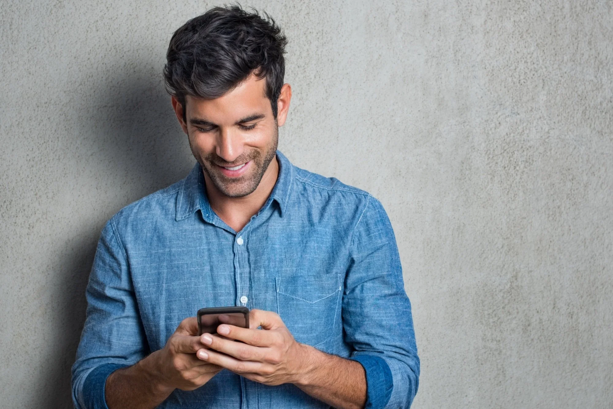 A spouse left behind using his cellphone.