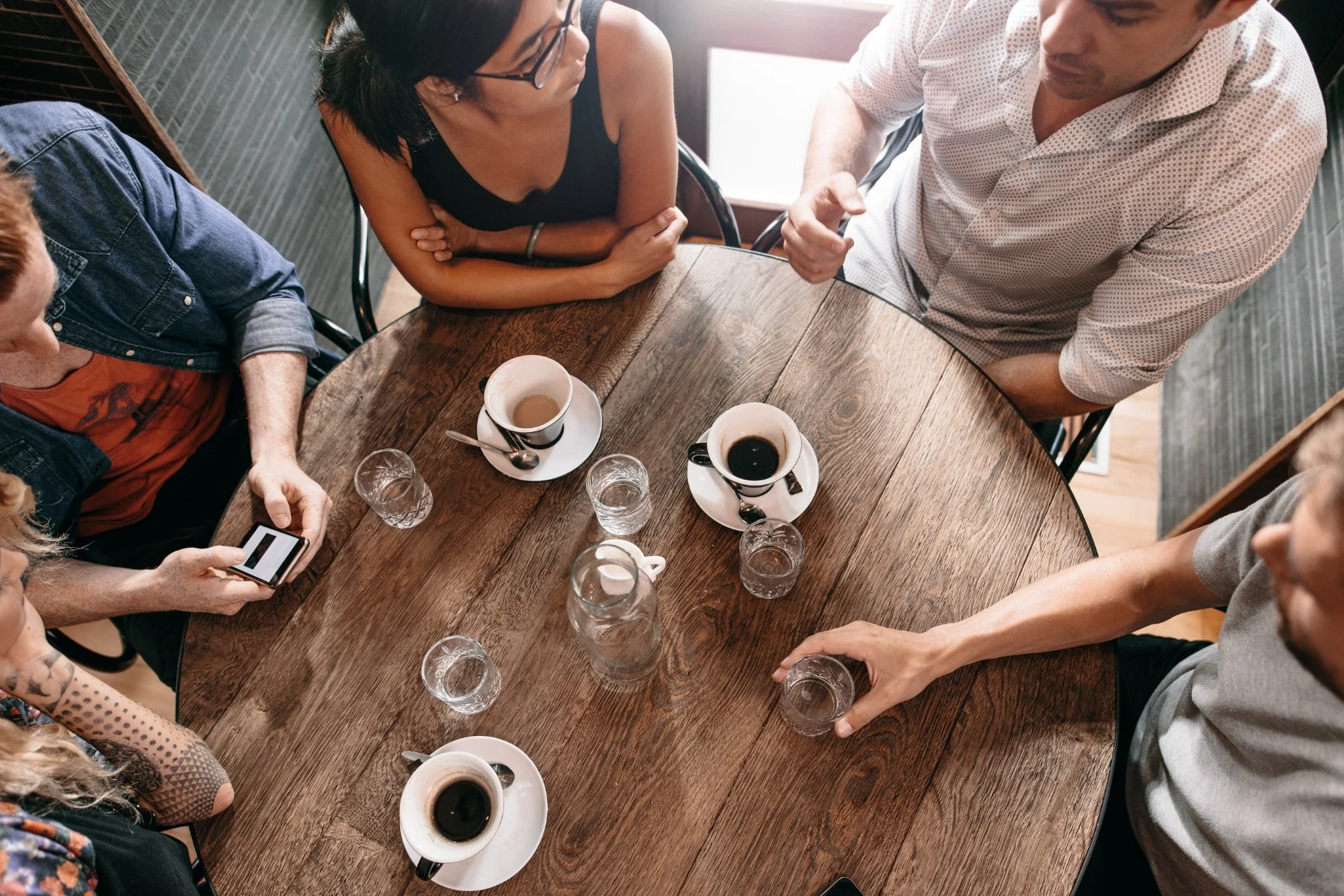 A spouse left behind drinking coffee with friends.
