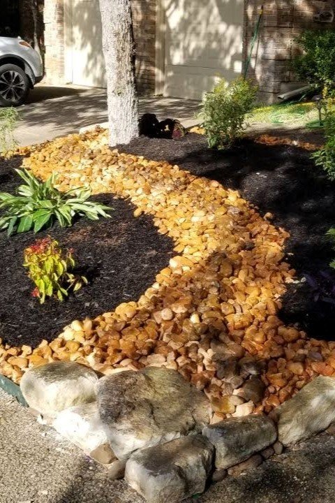 Tropical Plants with River Rock and Black Mulch