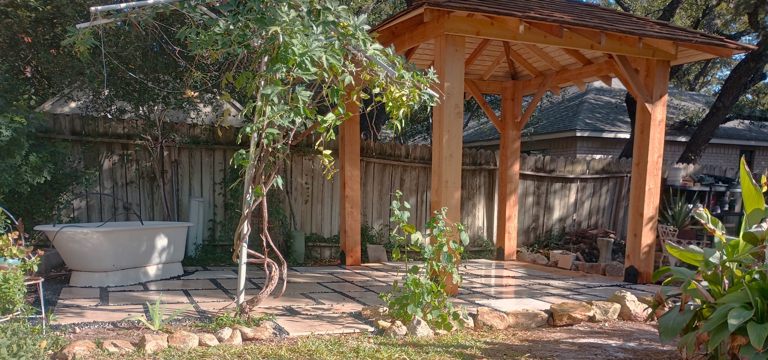 Stone Patio With Shadow Rock Joints And Bathtub Water Feature And Cedar Pergola