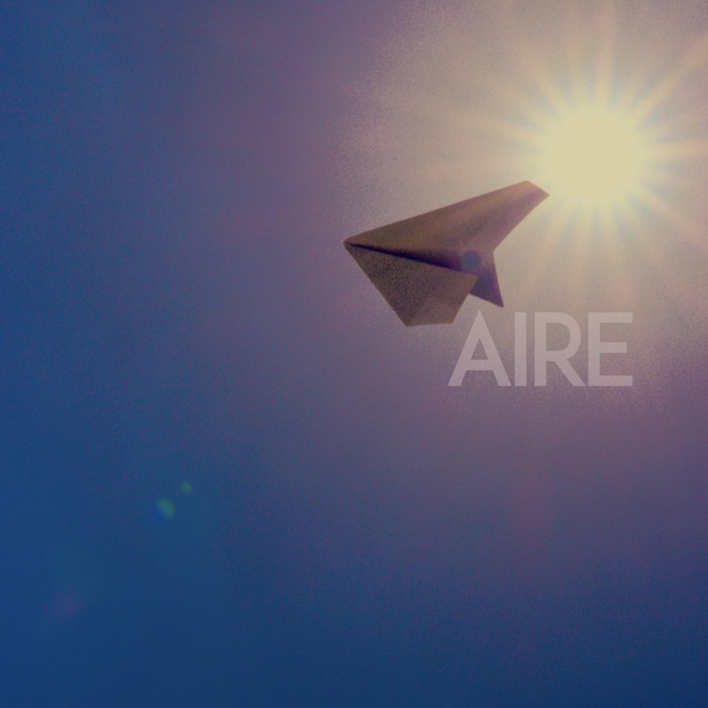 A paper airplane flying in the sky with the sun shining behind it and the word 'AIRE' faintly visible.