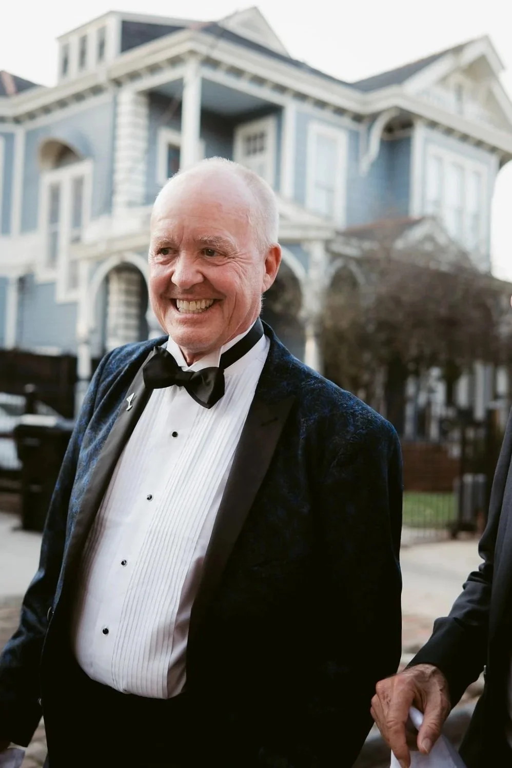 gentlmen wearing a bow tie and smiling 