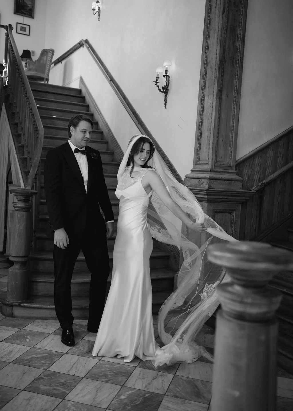 bride adjusting wedding veil by danielle frankel