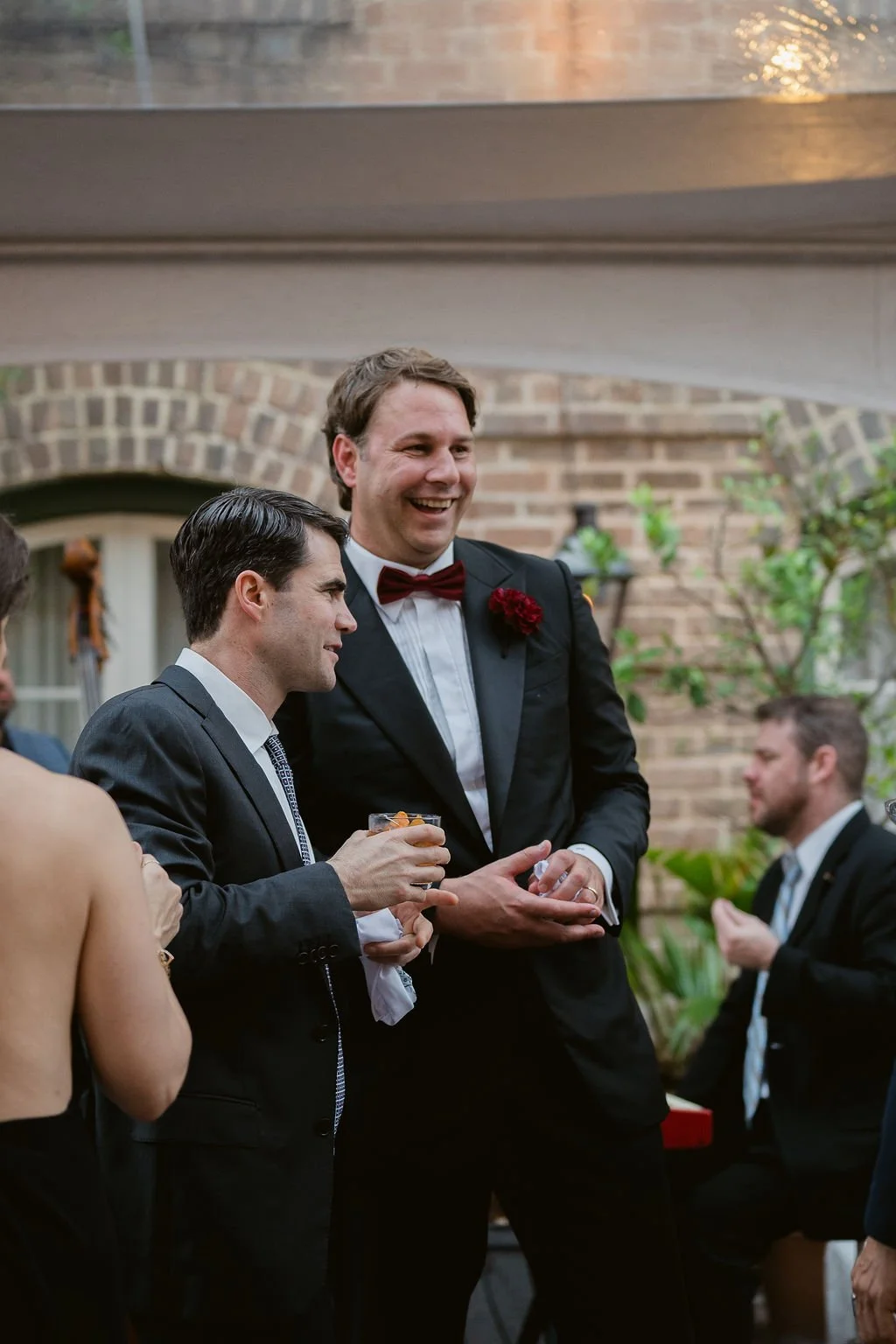 groom and groomsman laughing