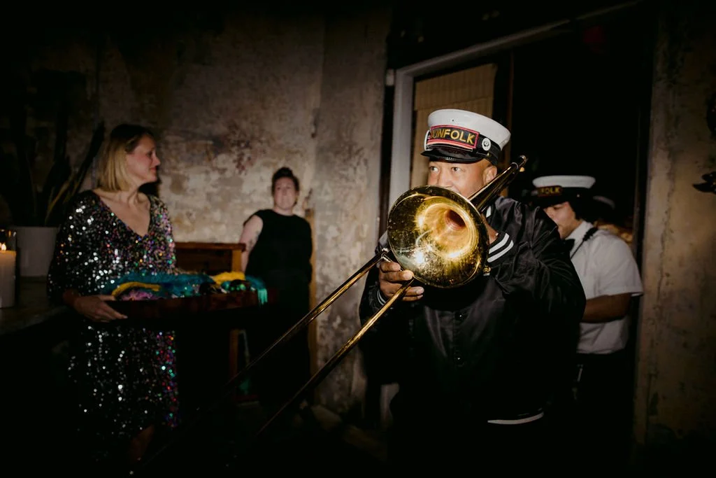 man blowing into the saxaphone