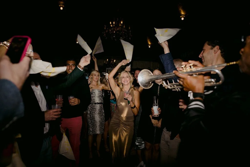 people dancing on the street waving handkerchiefs 