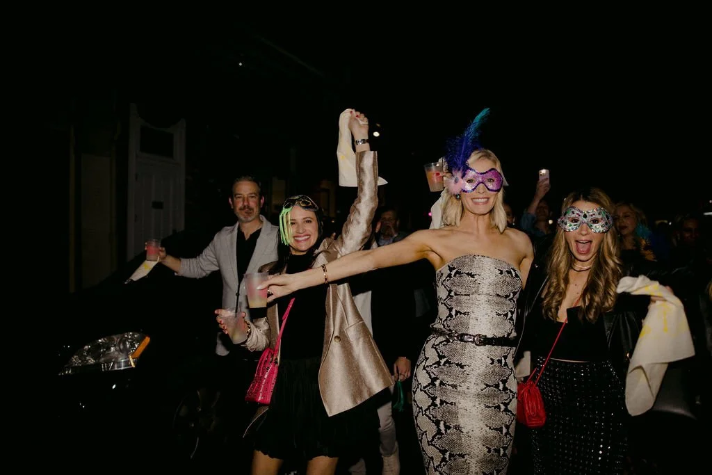 women wearing mardi gras masks