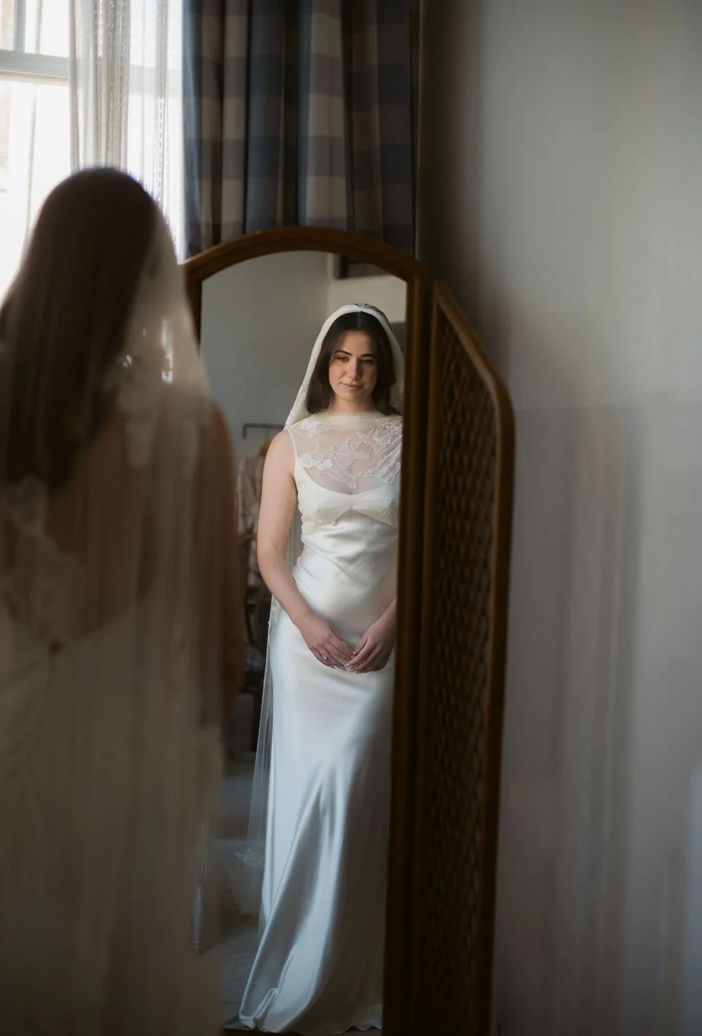 bride looking at herself in mirror