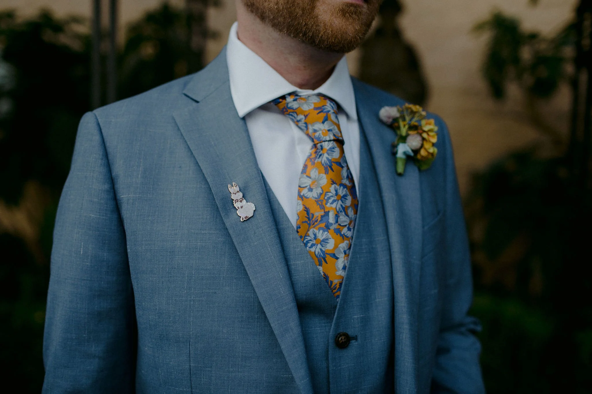 boutonniere clipped to a men's blue jacket
