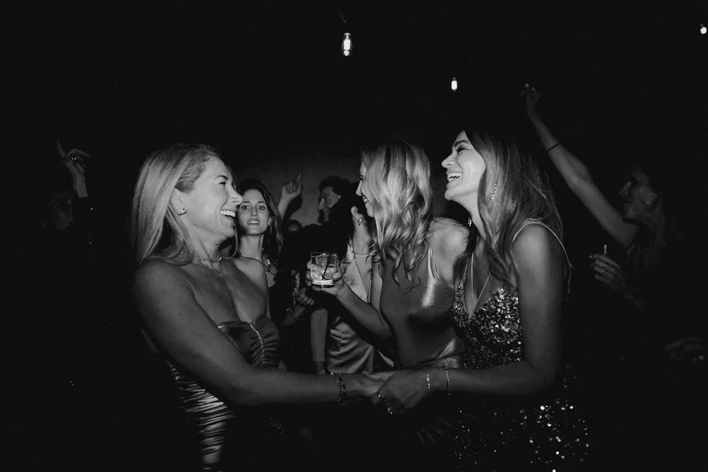 women hugging and dancing