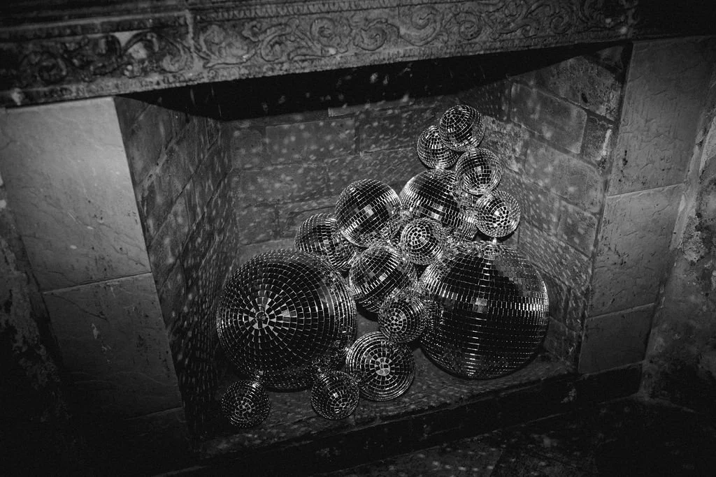 disco balls nestled in the fireplace