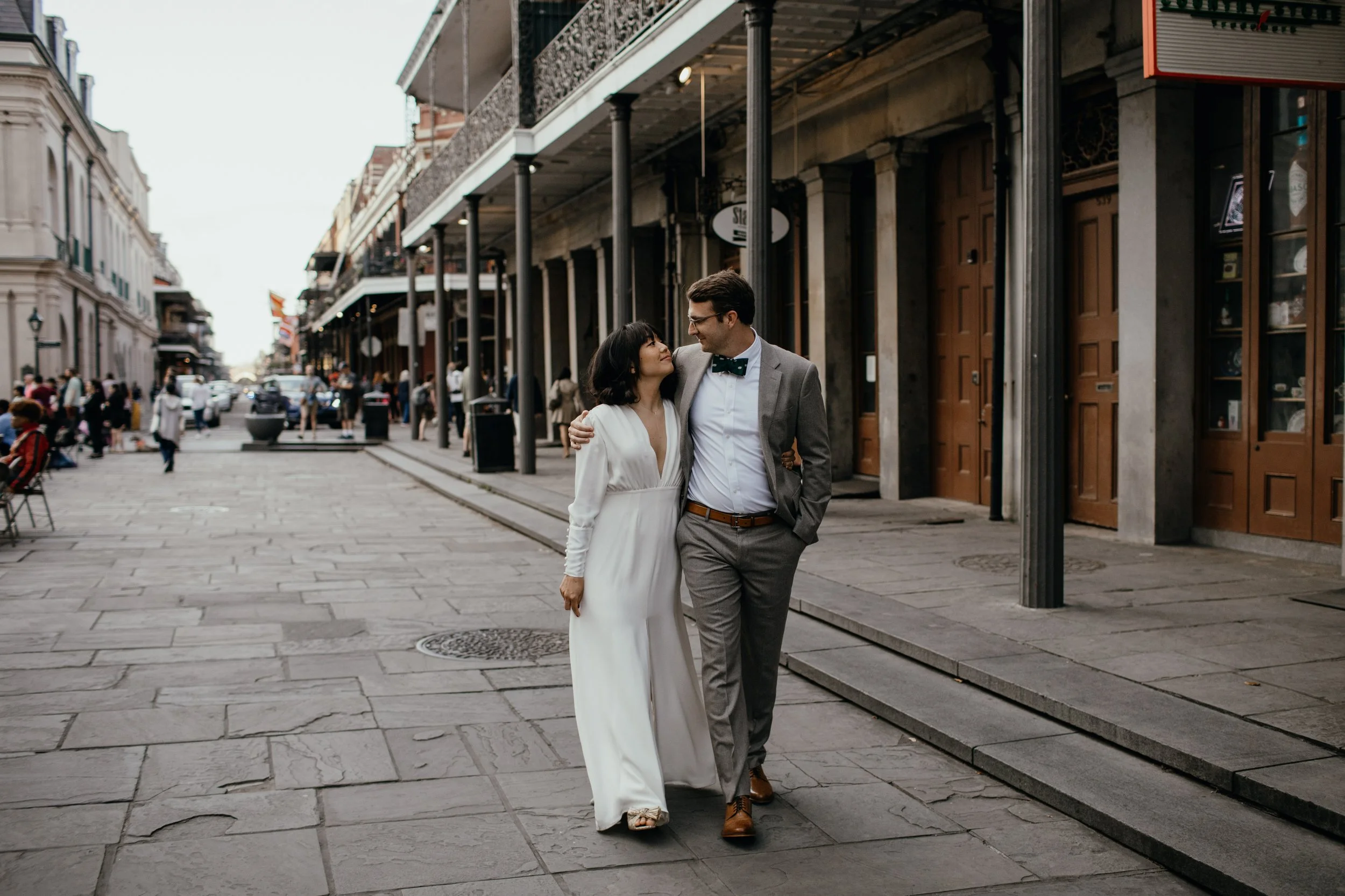Couple walking down a side street in the french quarter.
