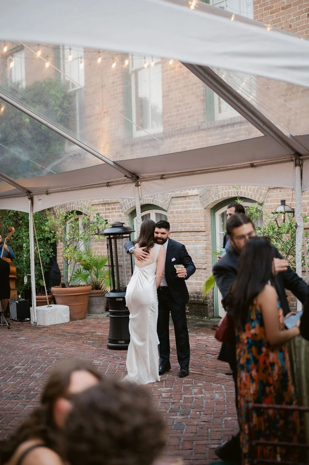 guest giving bride a hug