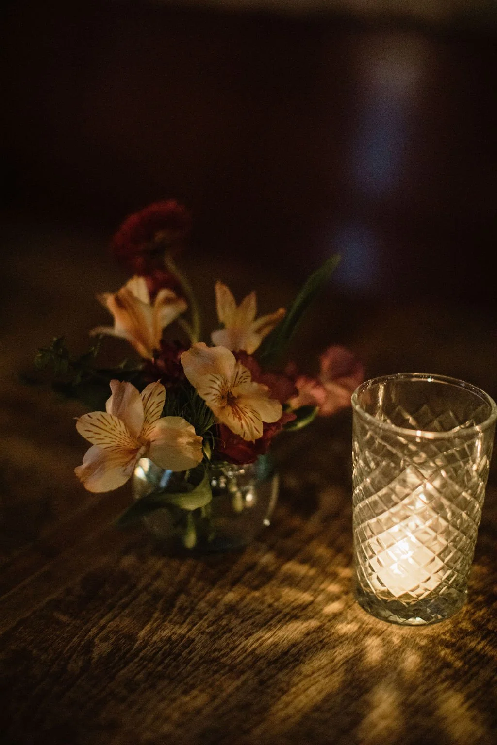 floral vase on table with candlight
