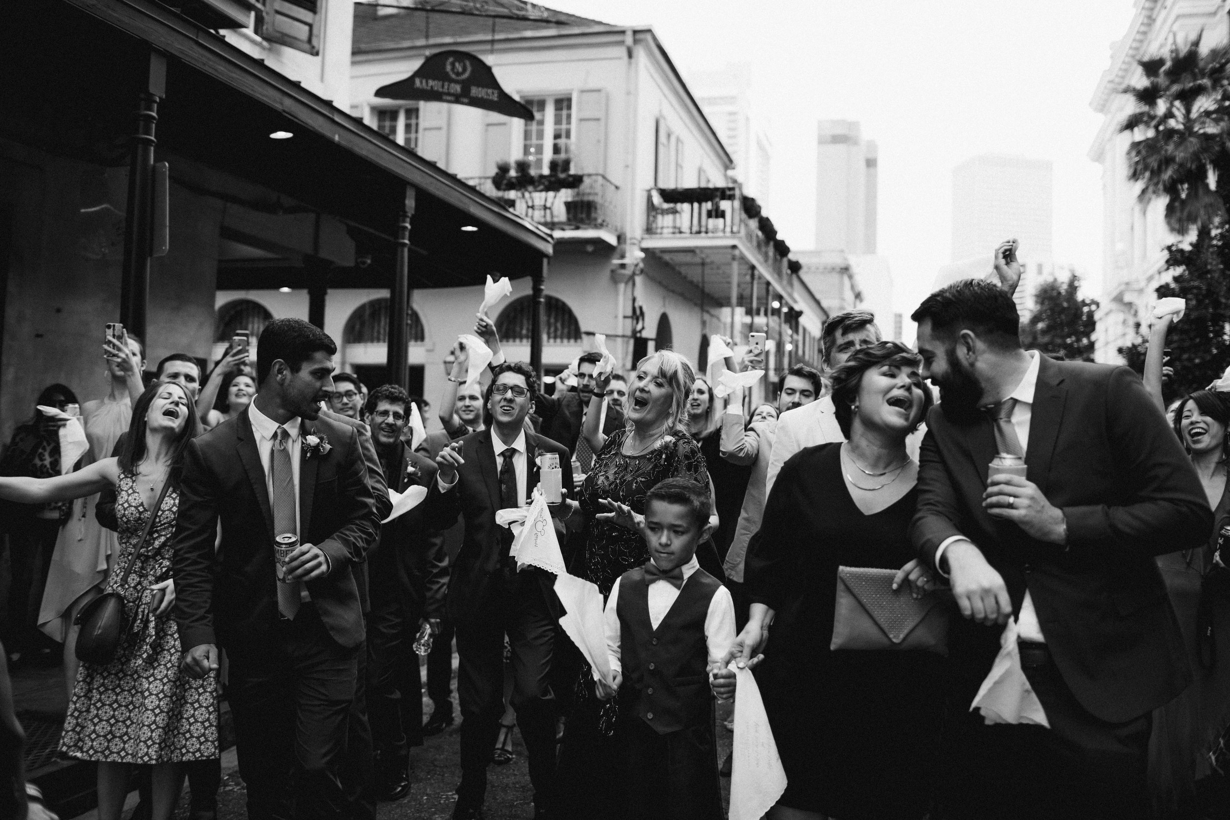 family sings to newly wed couple on a city street 