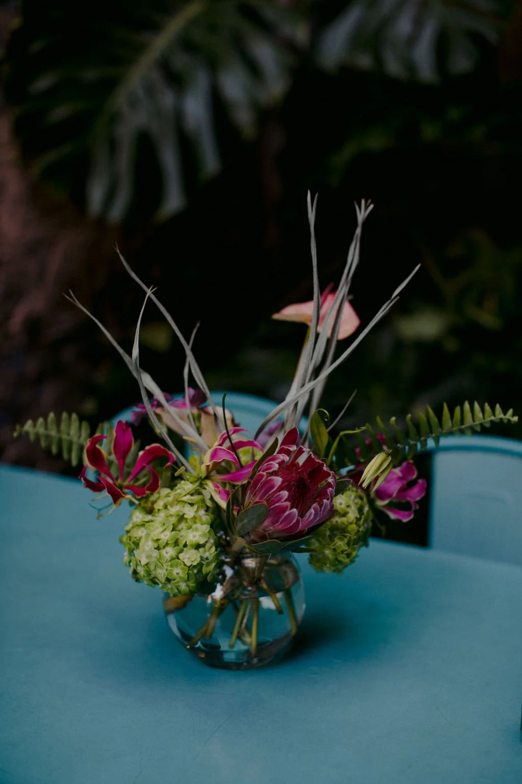 Floal vase with pink flowers on a blue table