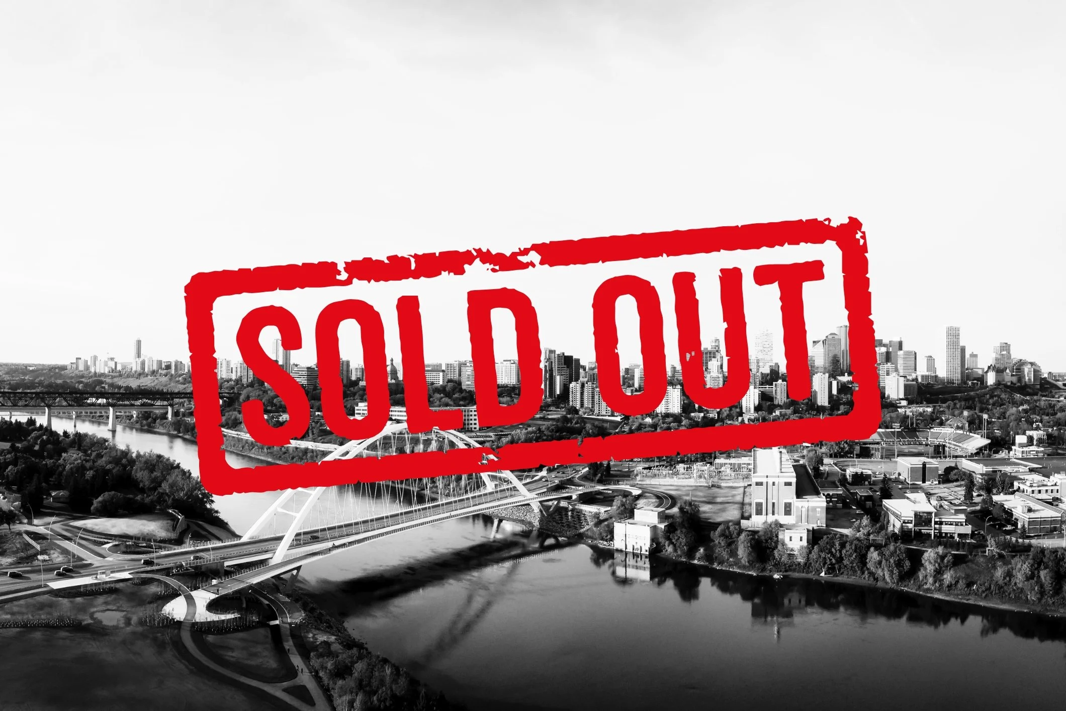 A red "sold out" stamp is superimposed over a black and white image of the Edmonton downtown skyline and river valley, indicating that Door Gurus has officially sold all of their Edmonton locations.