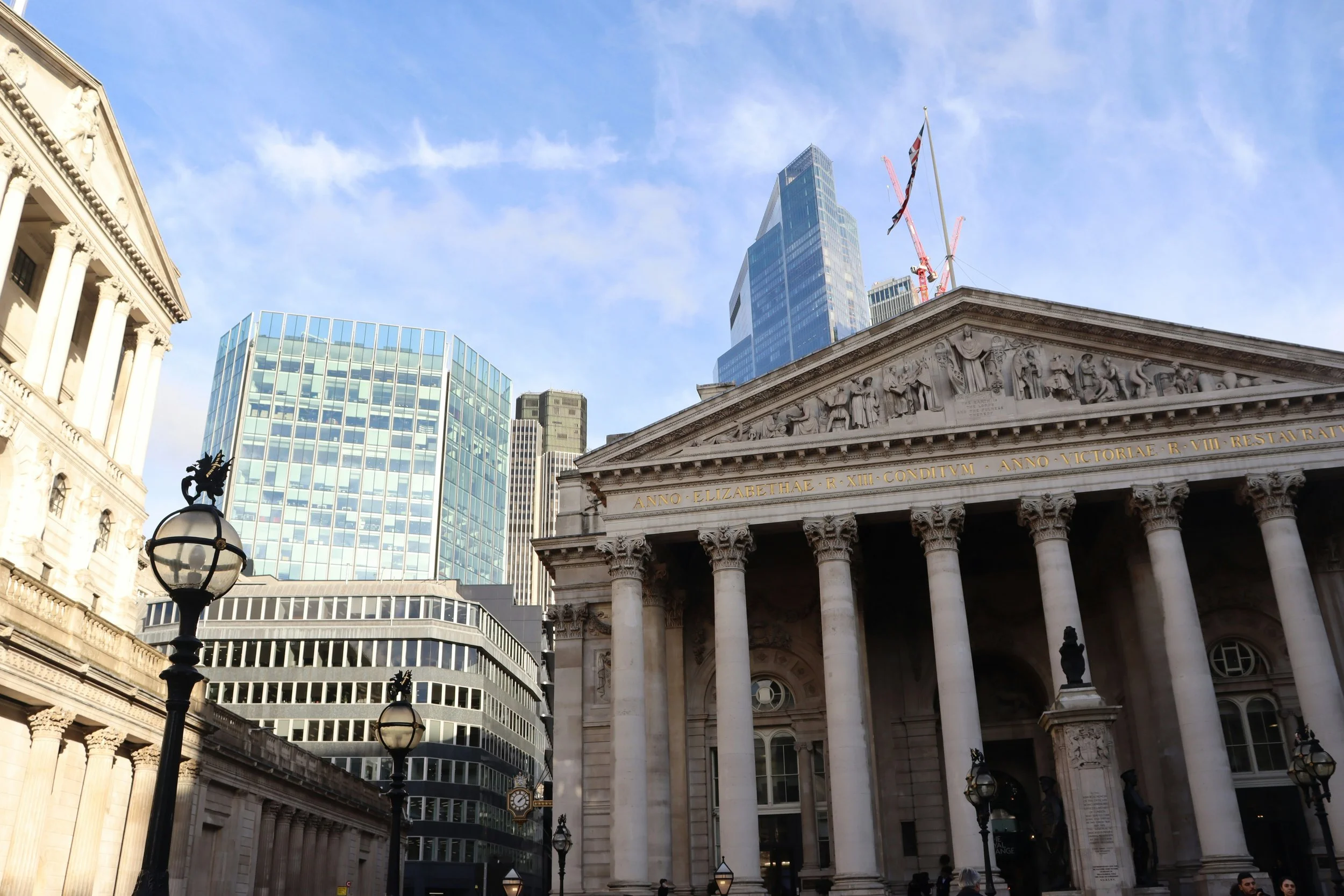 The image shows a mix of historic and modern buildings in London including the Bank of England