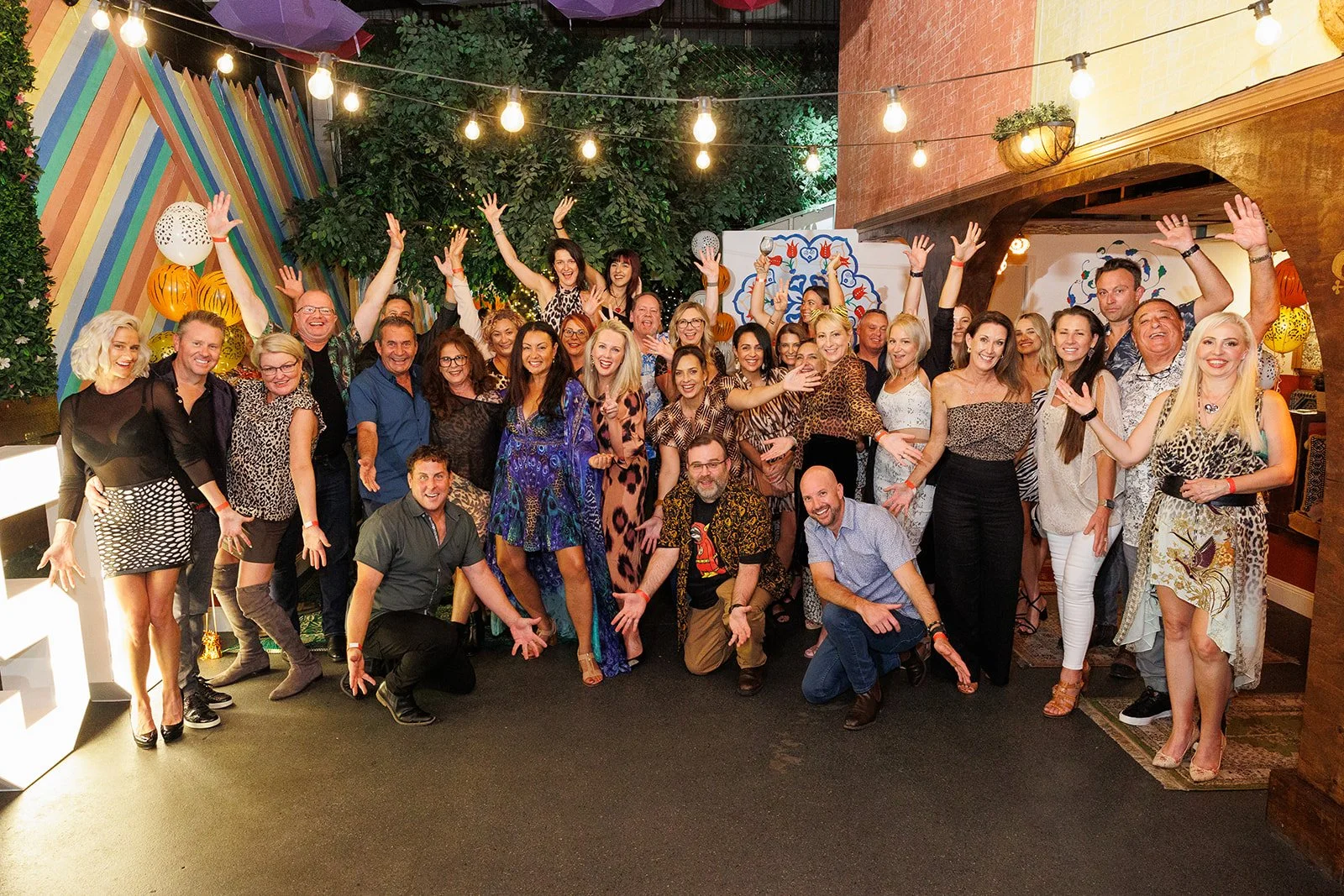 Group photo of multiple people having a great time at party