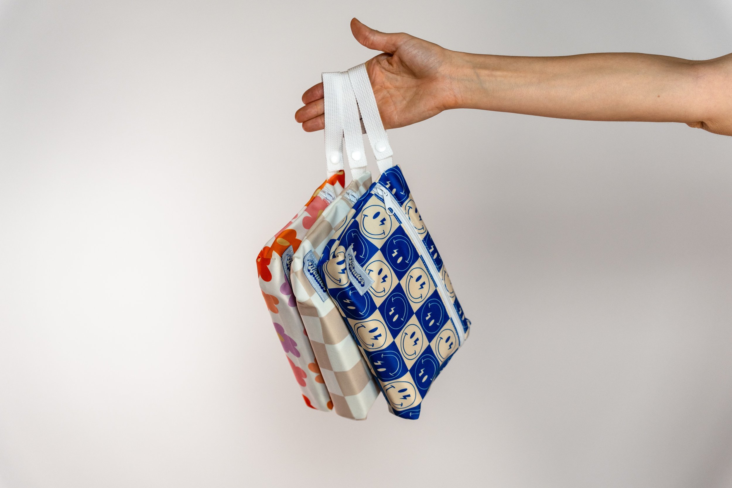 miles of wonder all three wet bags with mats in hand.jpg