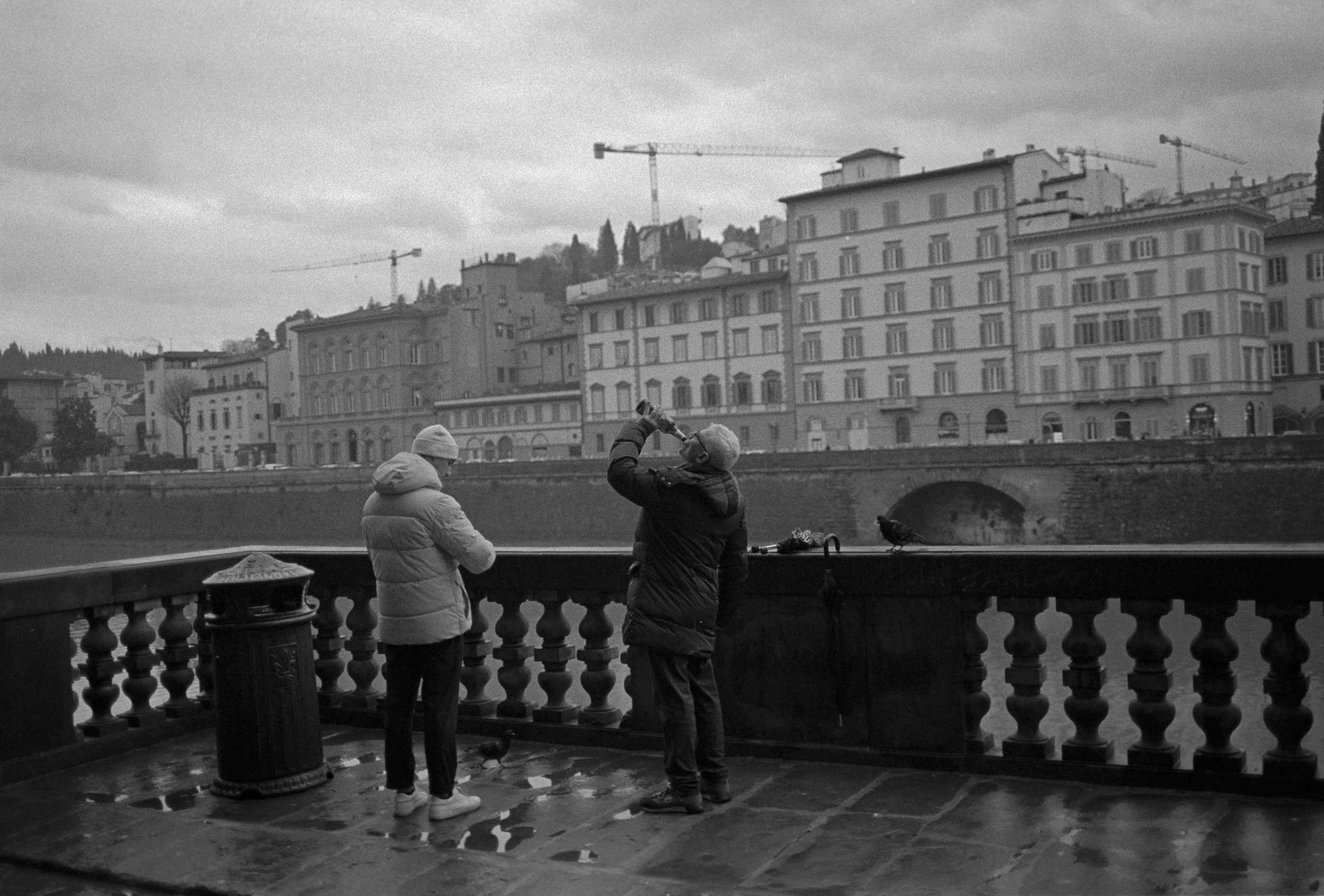 Man drinking down by the river.