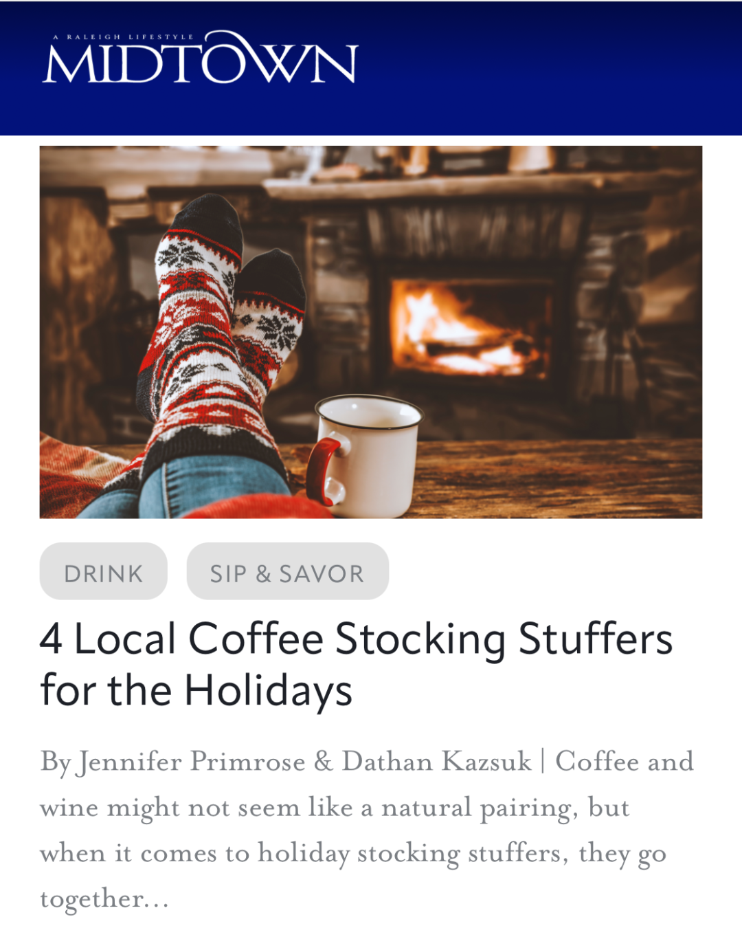 A cozy fireplace scene with a person wearing festive socks relaxing with a mug in front of a burning fire.