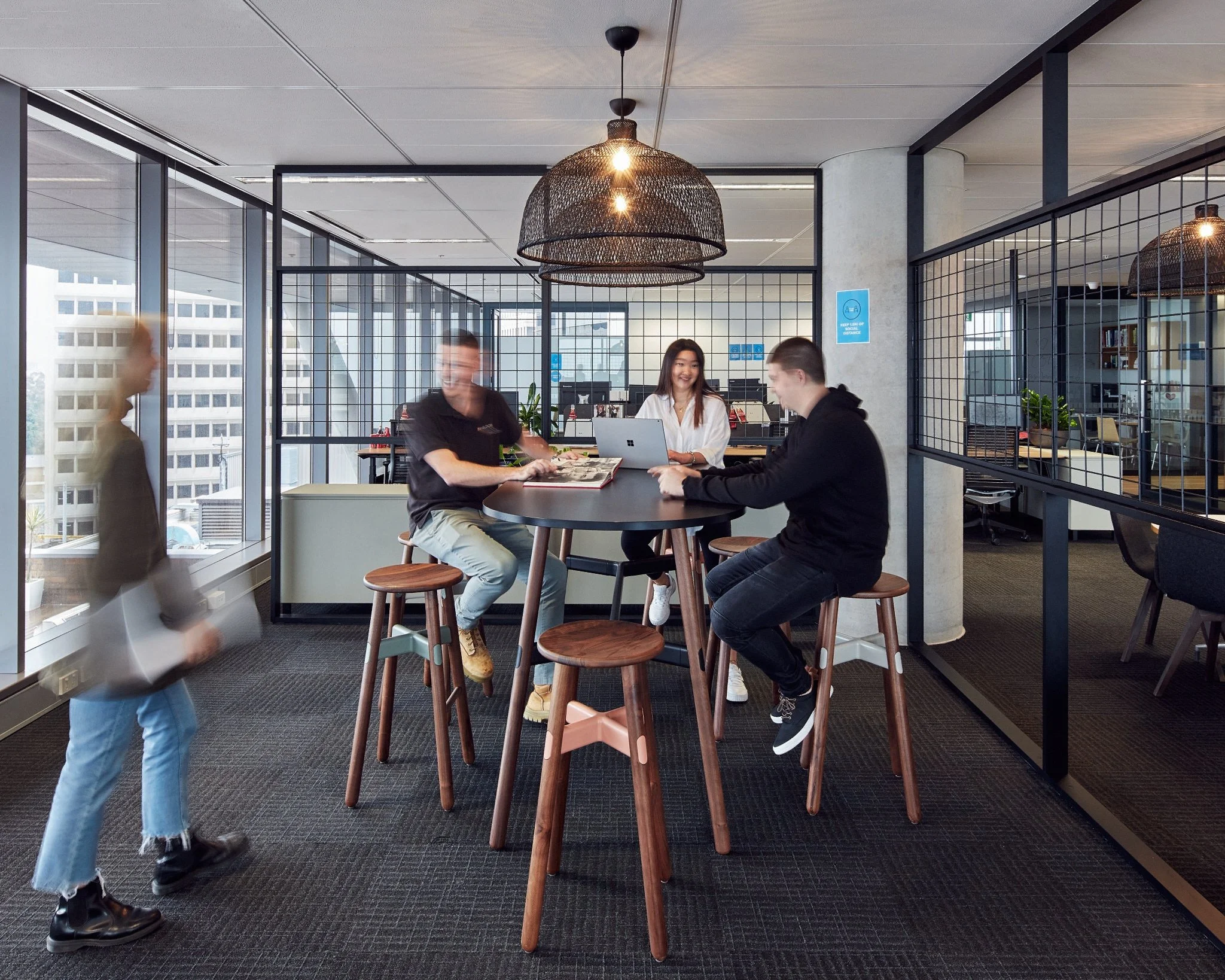 Novel Breakout Area showing workers coming together on a high table
