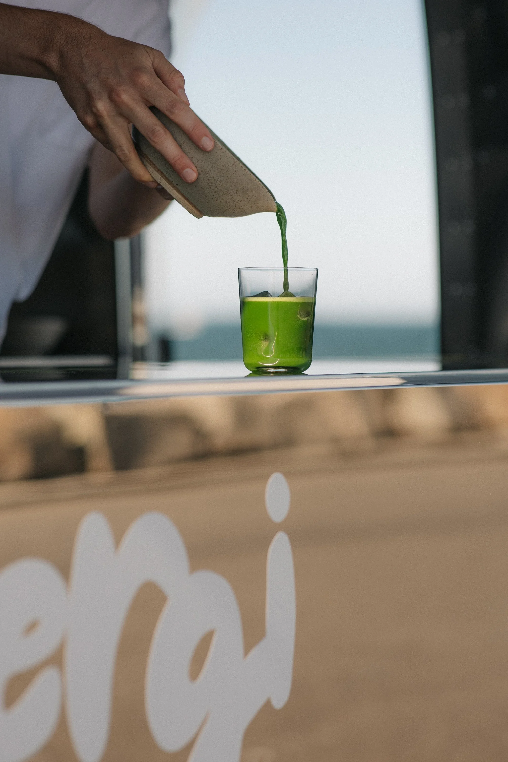Pouring matcha from matcha bowl into cup