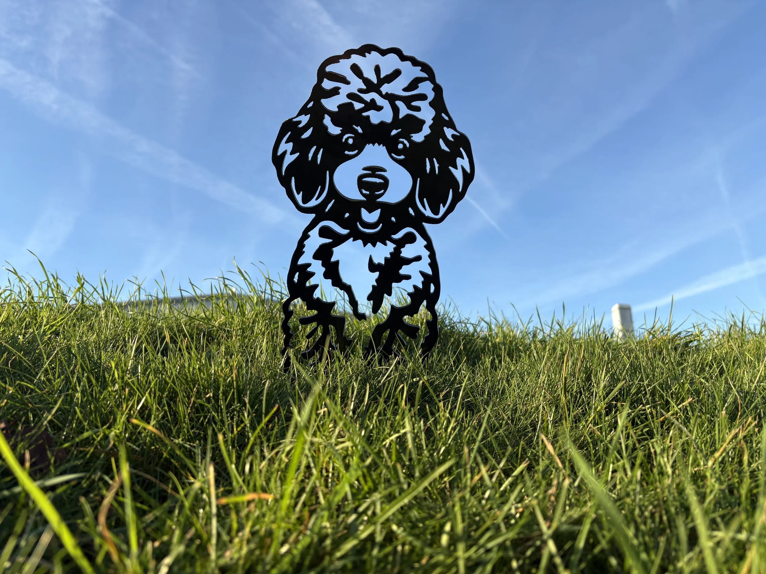 Elegant poodle metal garden ornament crafted from durable steel, designed to rust naturally and add charm to outdoor spaces.