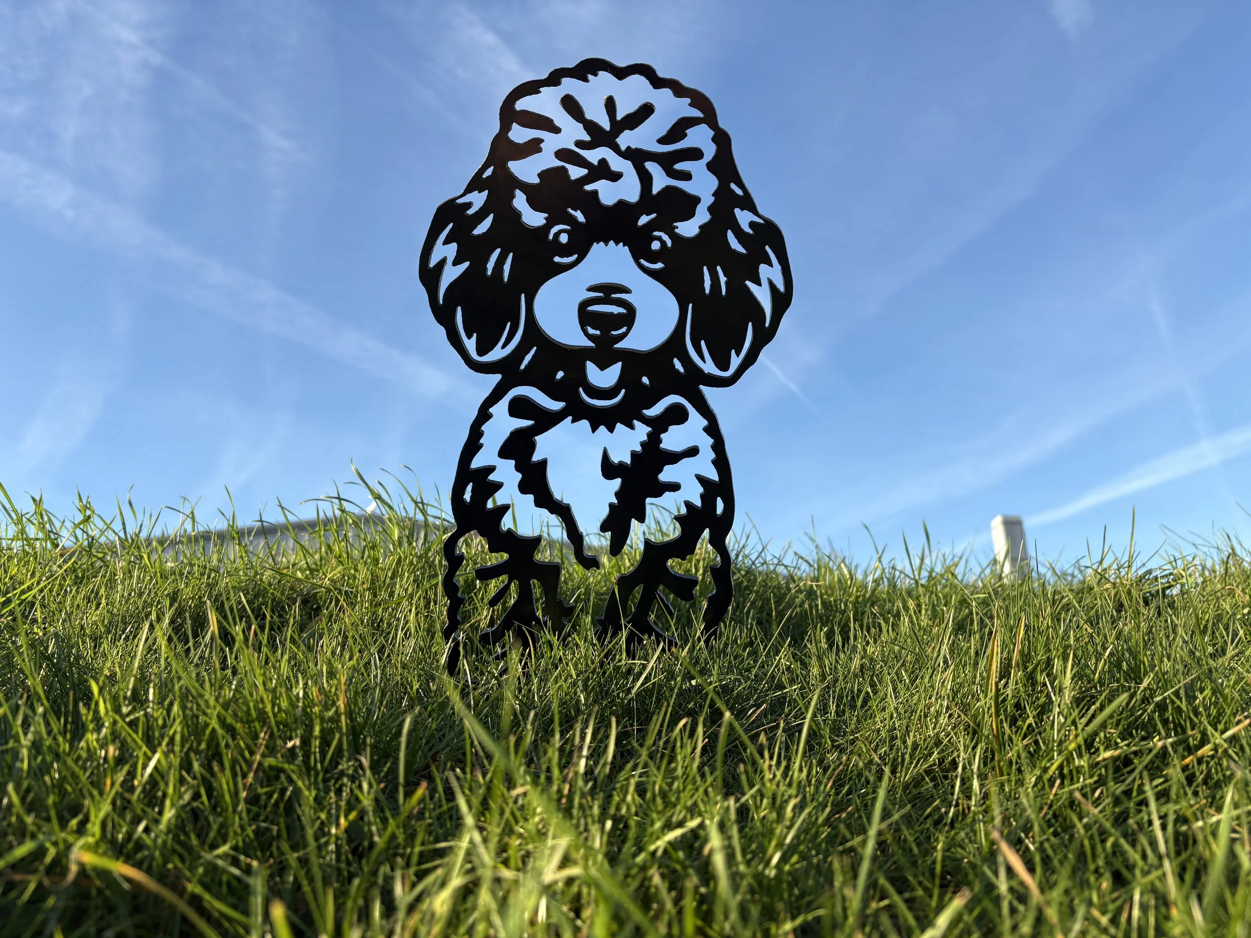 Decorative metal poodle silhouette garden art made from mild steel, designed to weather naturally for a warm rustic look.