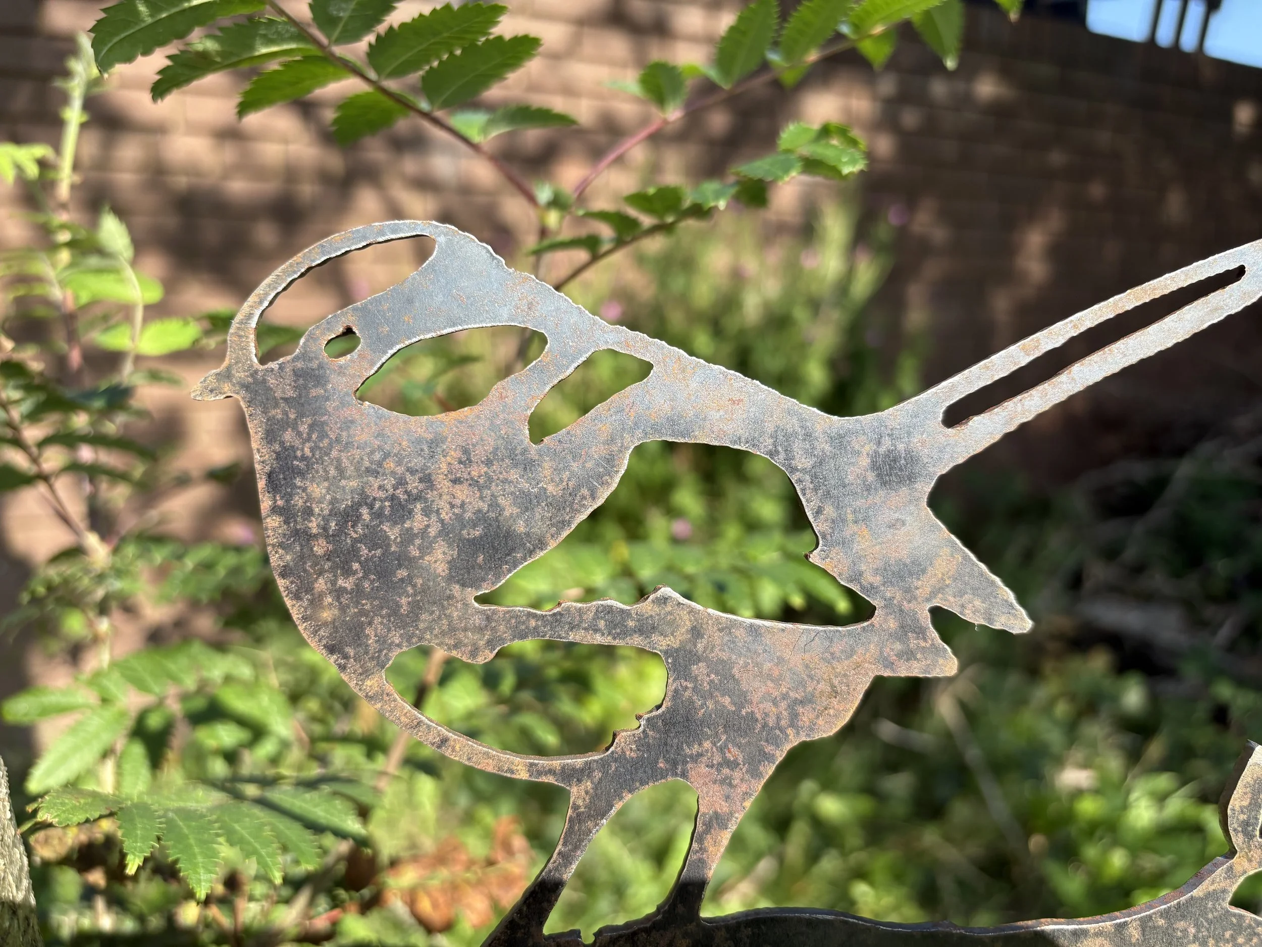 Blue tit silhouette metal art, precision-cut from 3 mm steel, ages into rich patina—ideal for garden posts, planters, or tree stumps.
