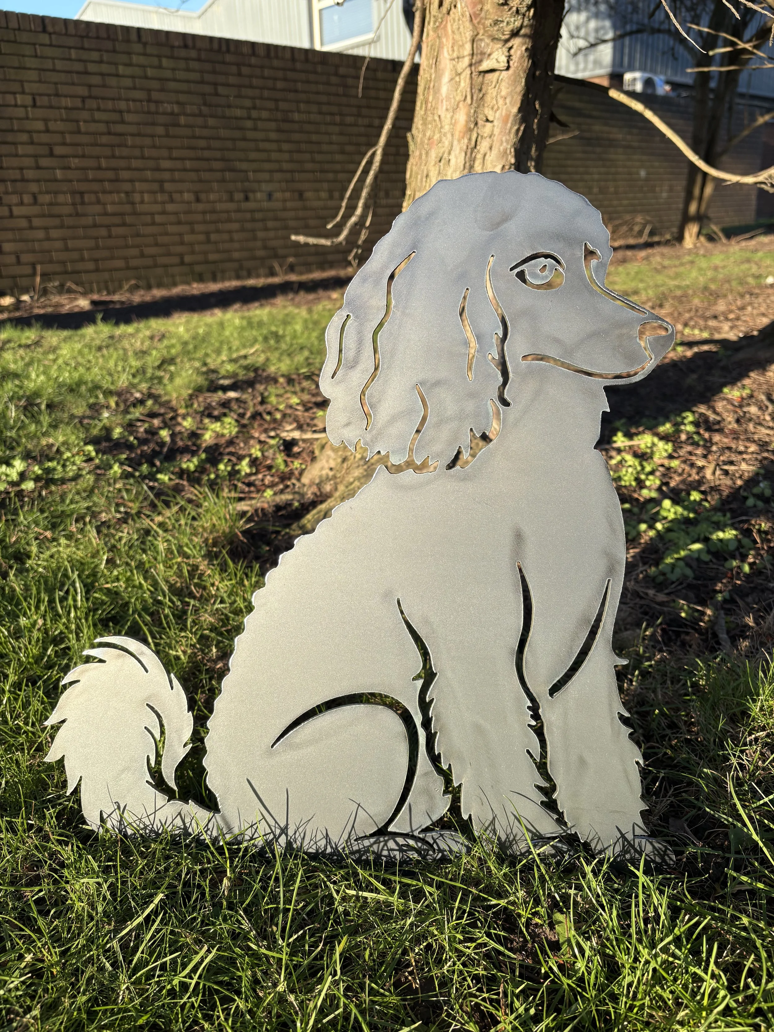 Sitting poodle metal garden art silhouette crafted from steel, designed to rust naturally and add charm to outdoor spaces.