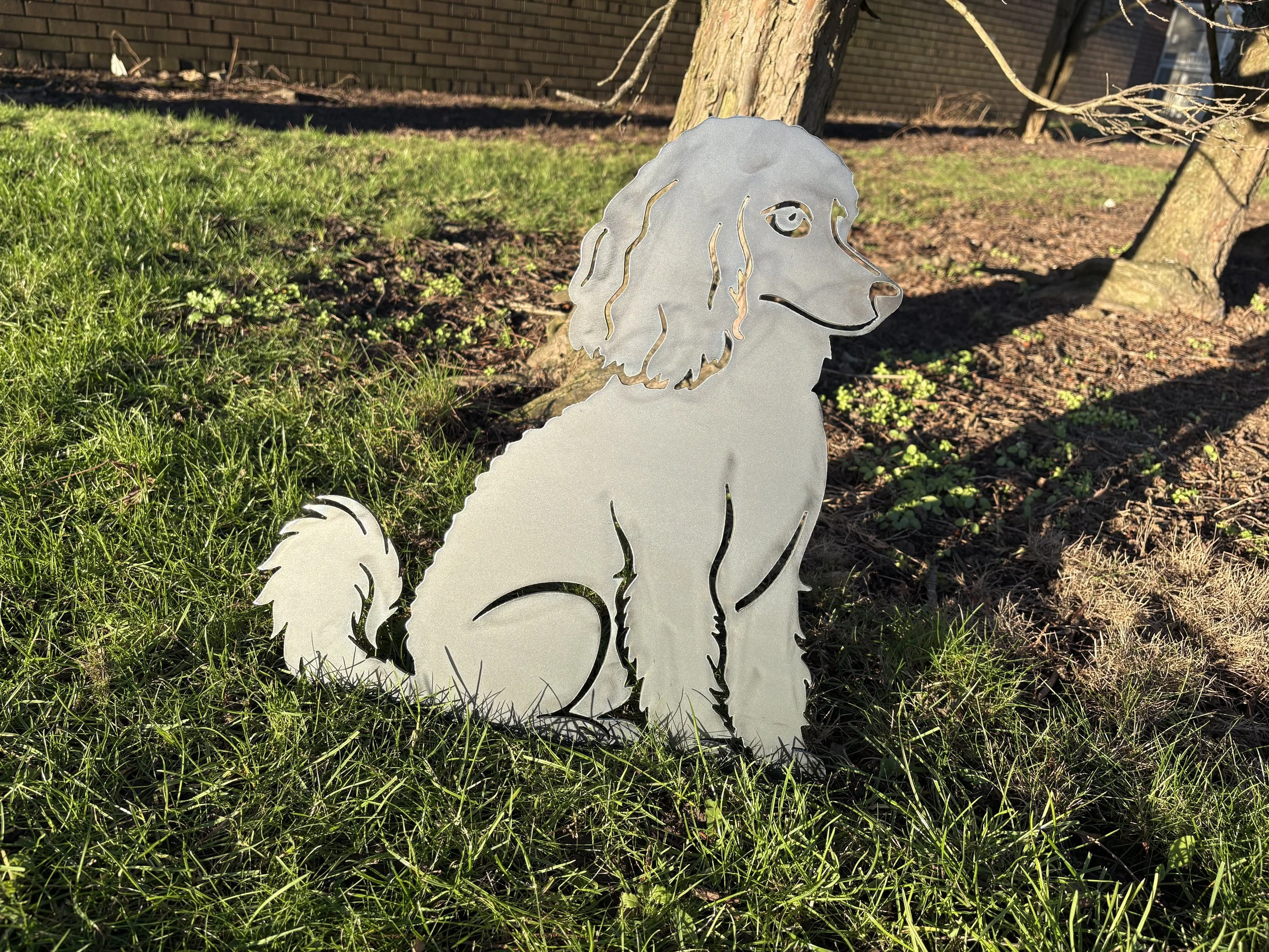 Decorative metal sitting poodle dog silhouette garden art with a natural rust finish for a warm rustic look.