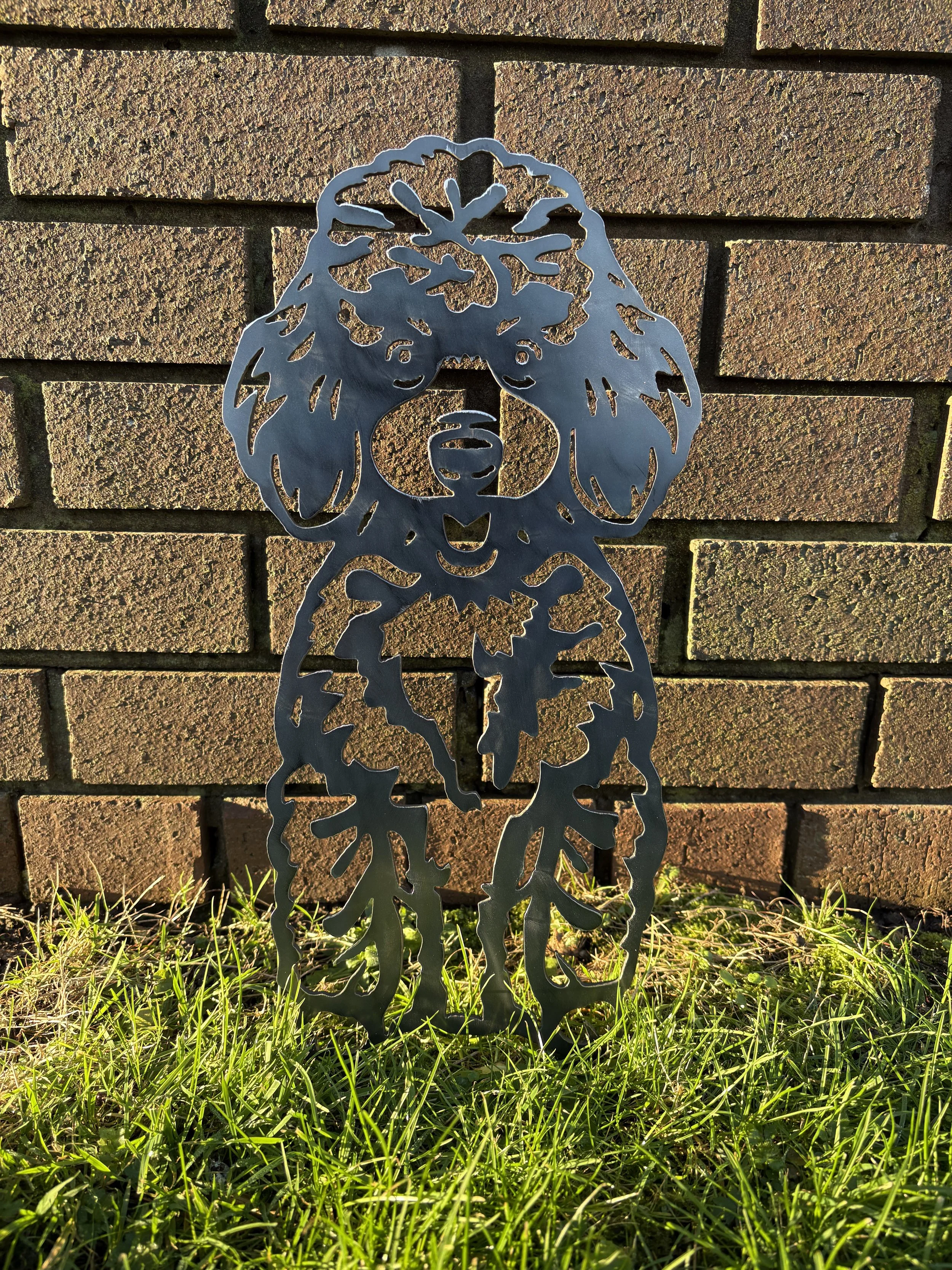 Poodle dog metal silhouette garden art with a natural rust finish, perfect for adding personality to flowerbeds or lawns.