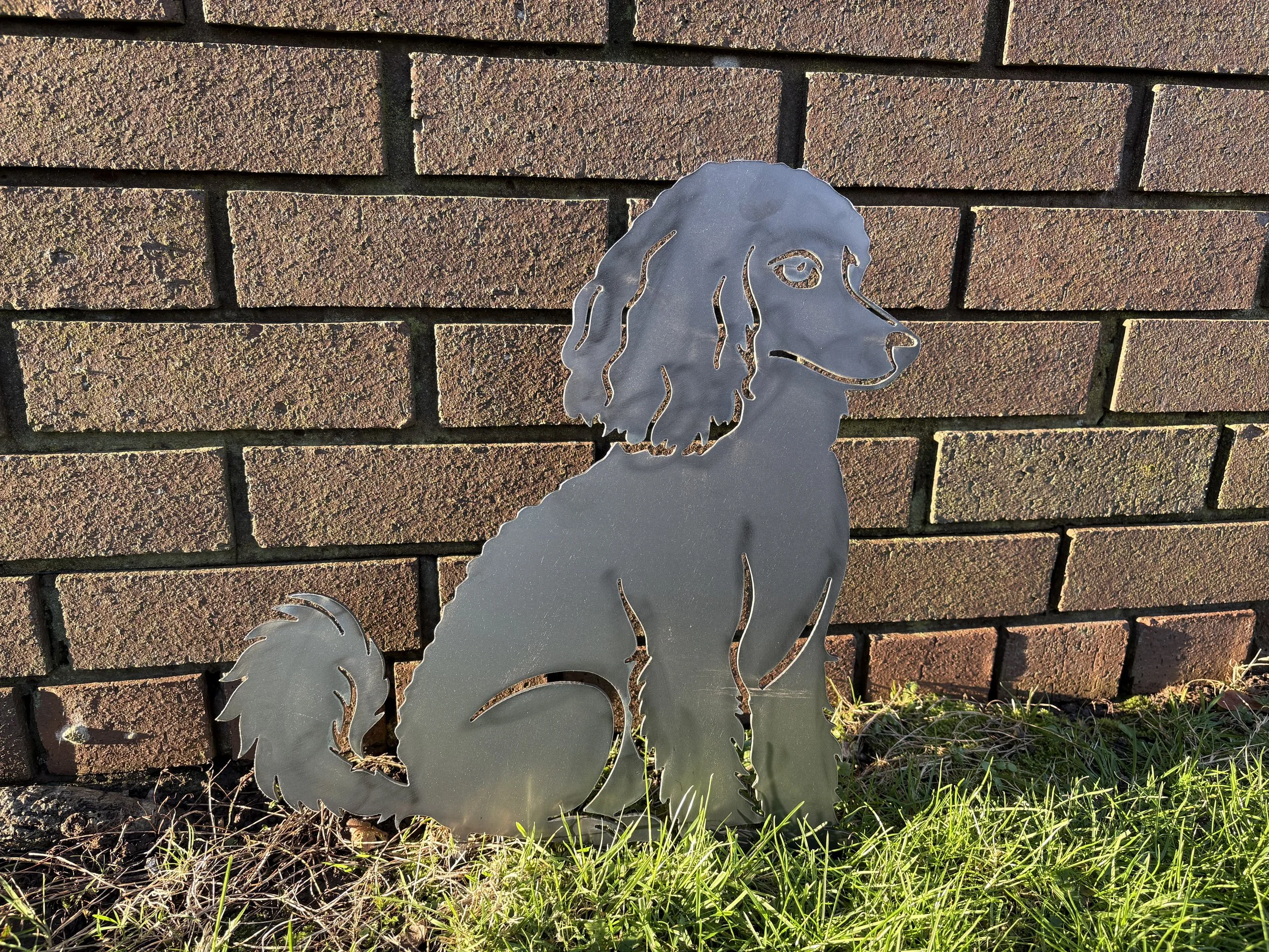 Sitting poodle metal silhouette garden art offering elegance and character, ideal for patios, flowerbeds, or lawns.