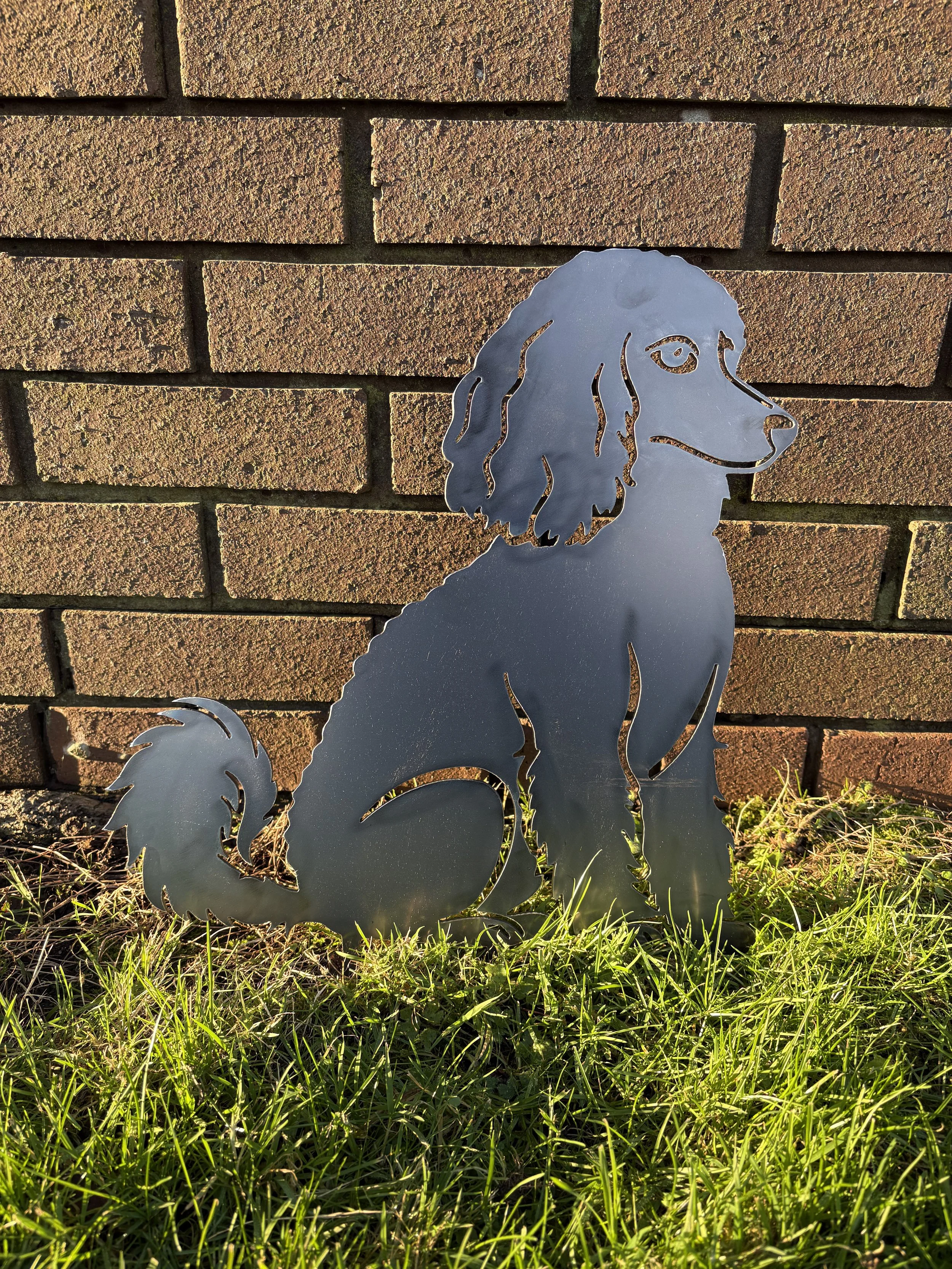 Rustic metal sitting poodle dog garden decoration designed to weather naturally and blend beautifully into gardens.