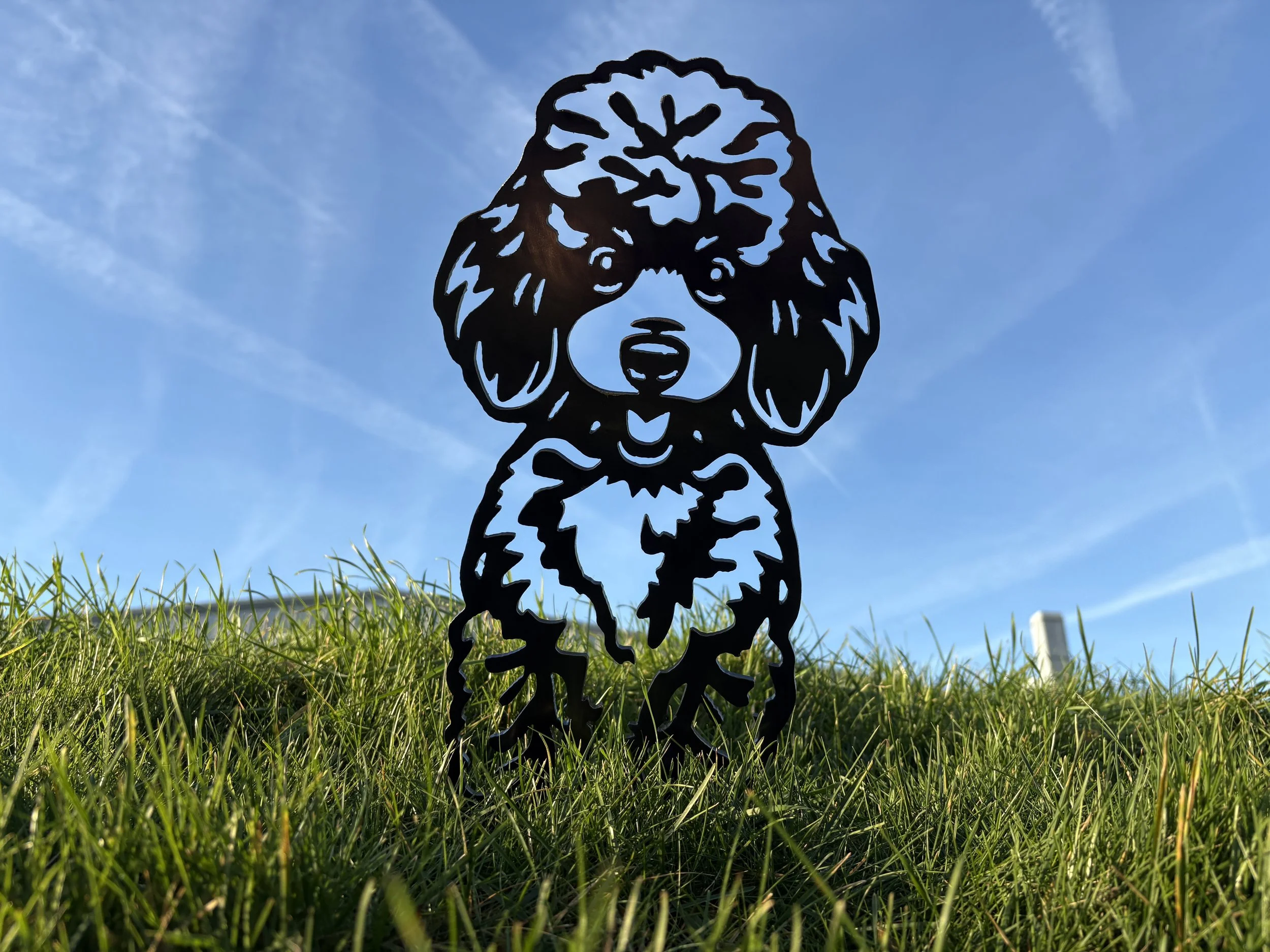 Hand finished metal poodle garden art silhouette made in the UK, featuring a rustic steel finish perfect for lawns, borders, and patios.