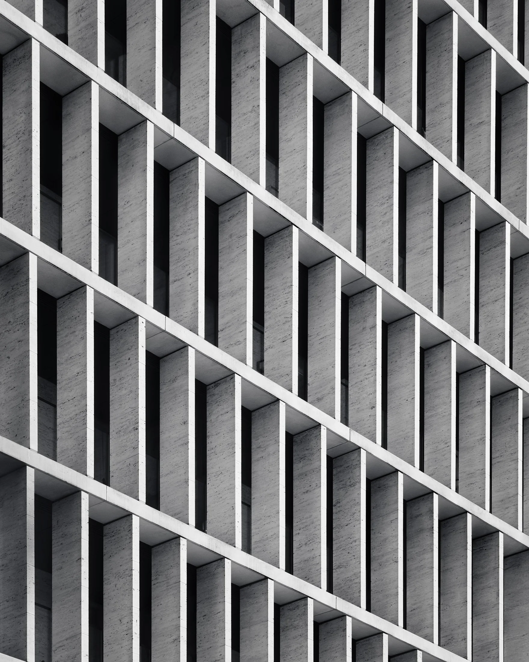 [architecture] [uk] [london] [blackandwhite] 62 Buckingham Gate London, abstract close study of repeating travertine concrete fins and deep-set window bays. Architectural Photography by Jim Scott.