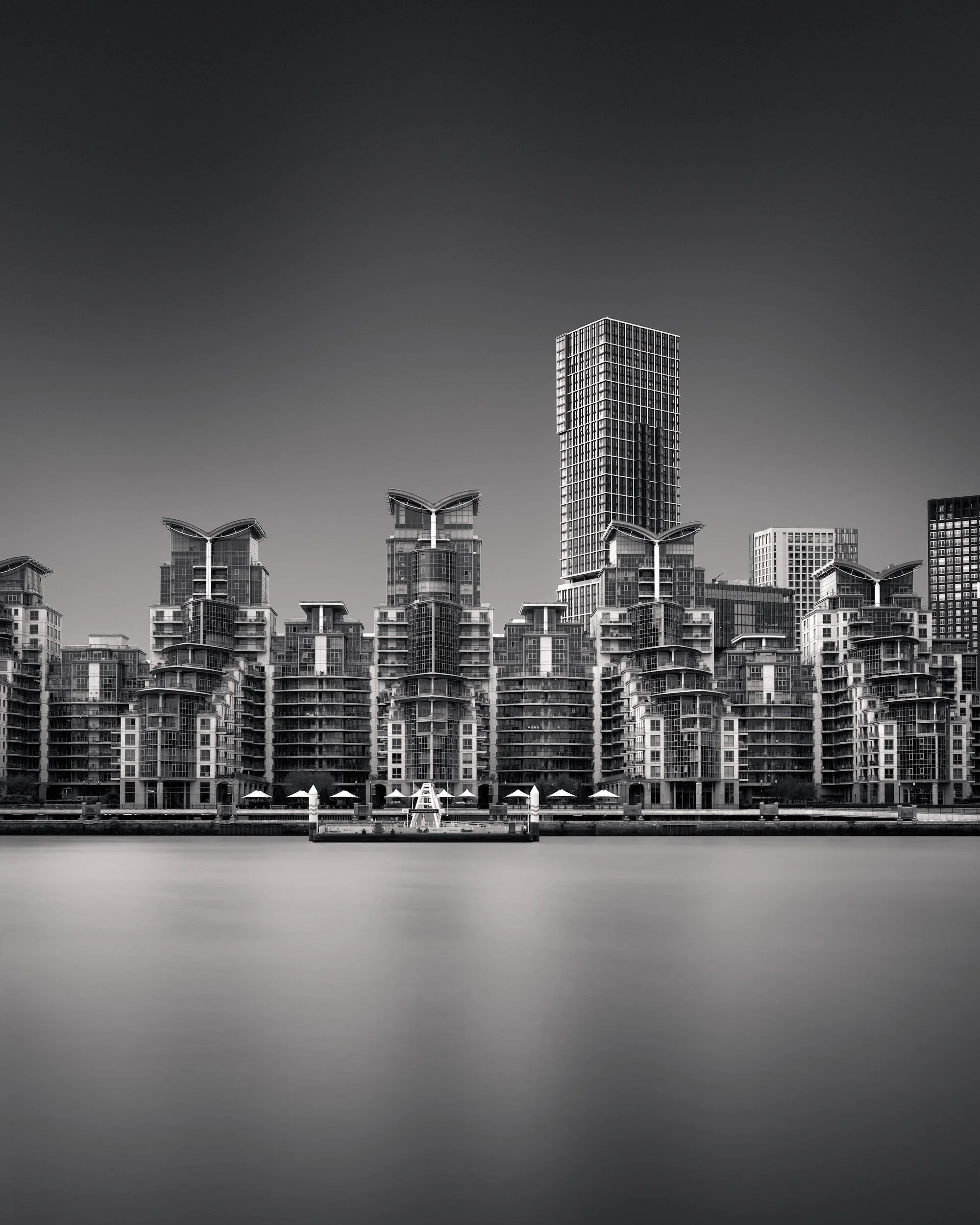 [architecture] [uk] [london] [blackandwhite] St George Wharf London B&W, dense layered residential complex with curved balconies and wing-topped towers. Architectural Photography by Jim Scott.