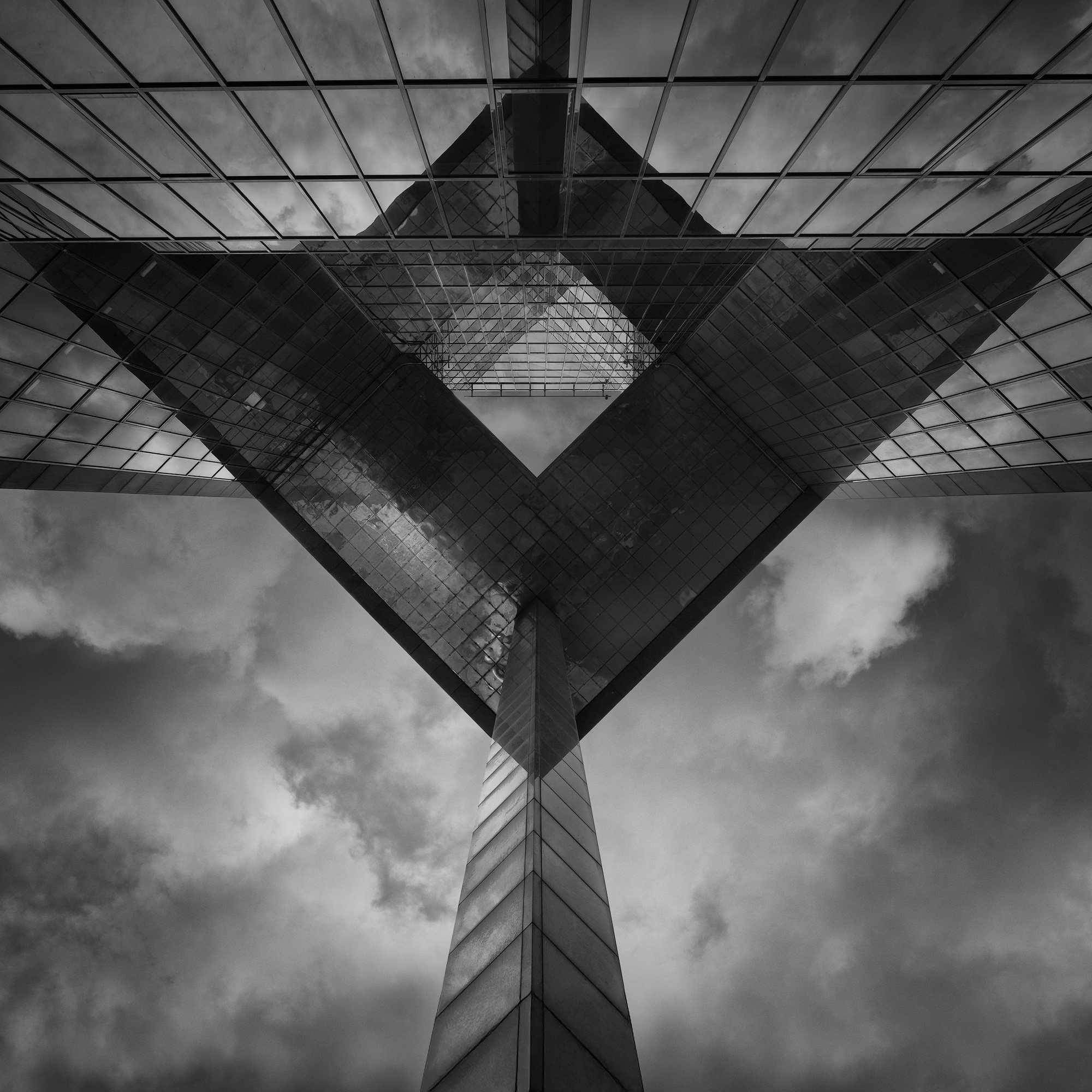[architecture] [uk] [london] [blackandwhite] [square] London Bridge from the Queen's Walk, glass cantilevered underside and angular steel structure reflected in the facade. Architectural Photography by Jim Scott.