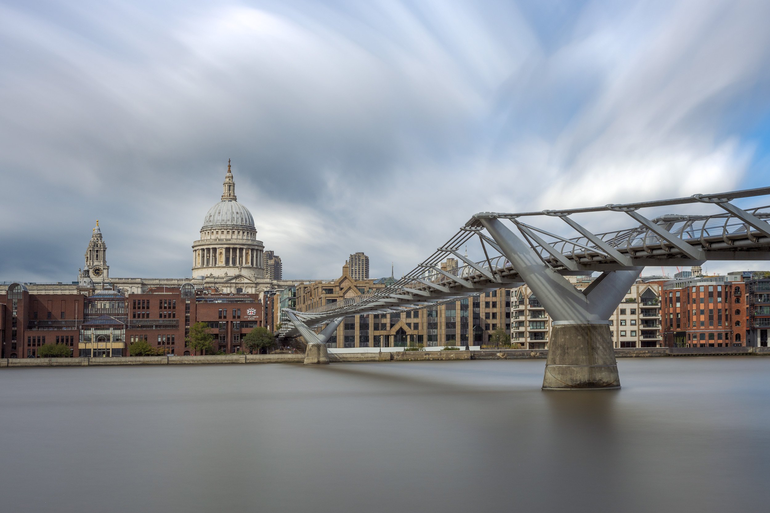 [architecture] [uk] [london] [colour] Millennium Bridge London long exposure, St Paul's Cathedral dome rising beyond the silk-smooth River Thames. Architectural Photography by Jim Scott.