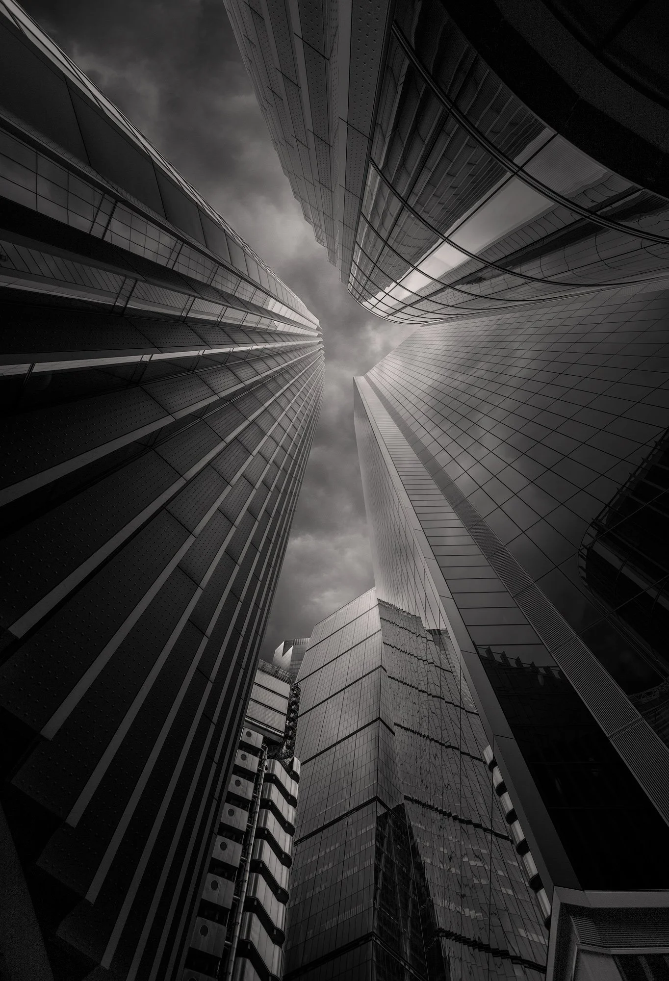 [architecture] [uk] [london] [blackandwhite] Leadenhall Building and The Scalpel London City cluster, looking up between converging glass towers, vertiginous black and white. Architectural Photography by Jim Scott.