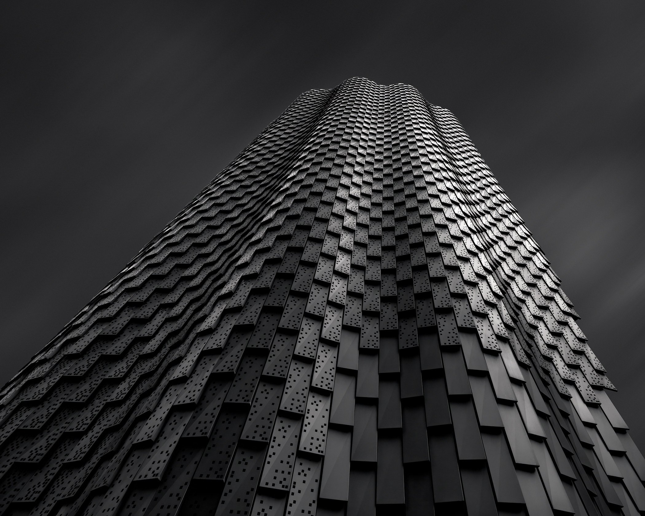 Contemporary commercial design in Broadgate, London: A dramatic monochromatic study of the Pavilion at 3 Broadgate, home to Redemption Roasters. Designed by Orms, this architectural photograph showcases the building’s unique undulating facade and rhy